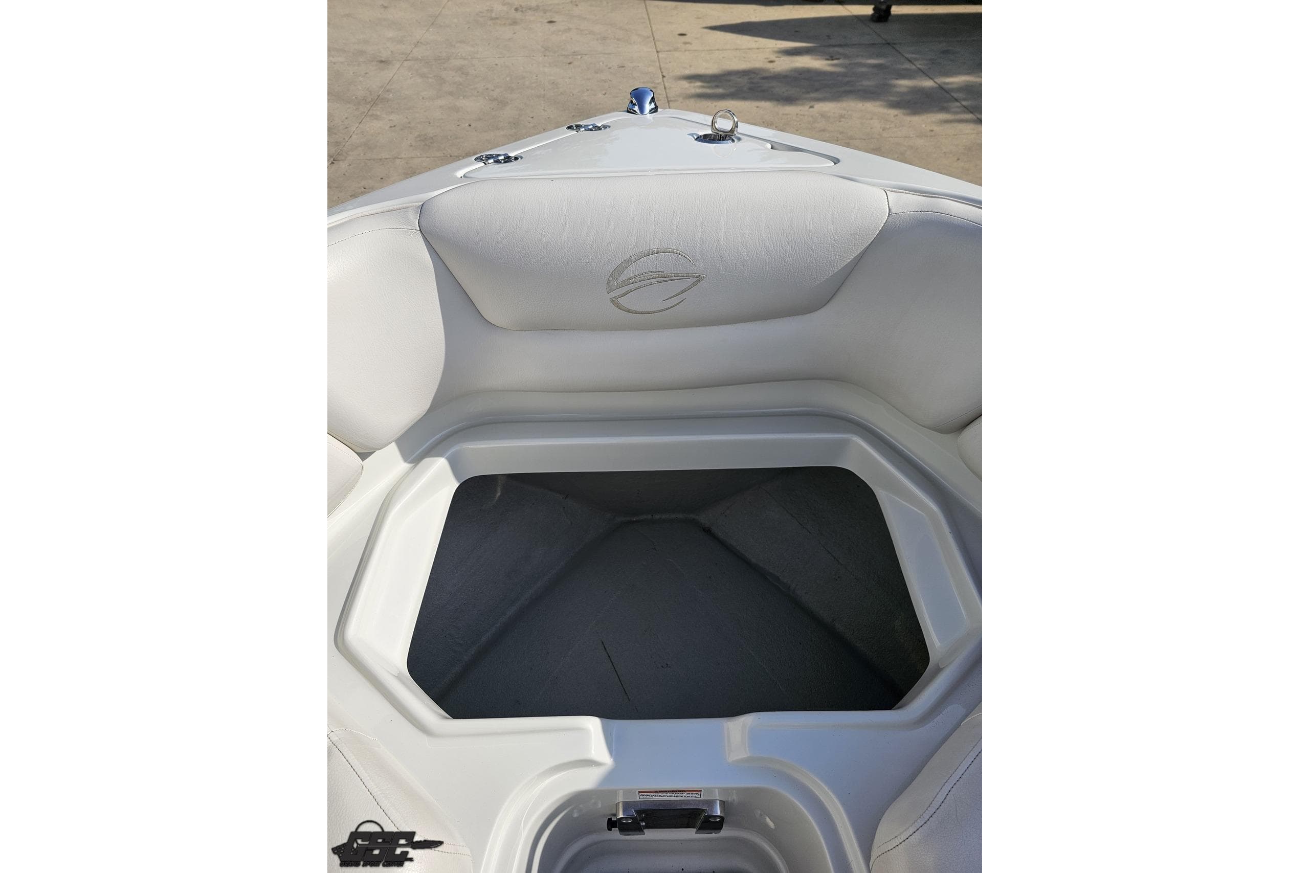 2019 Crownline 275 SS boat interior with white seating and storage compartment.