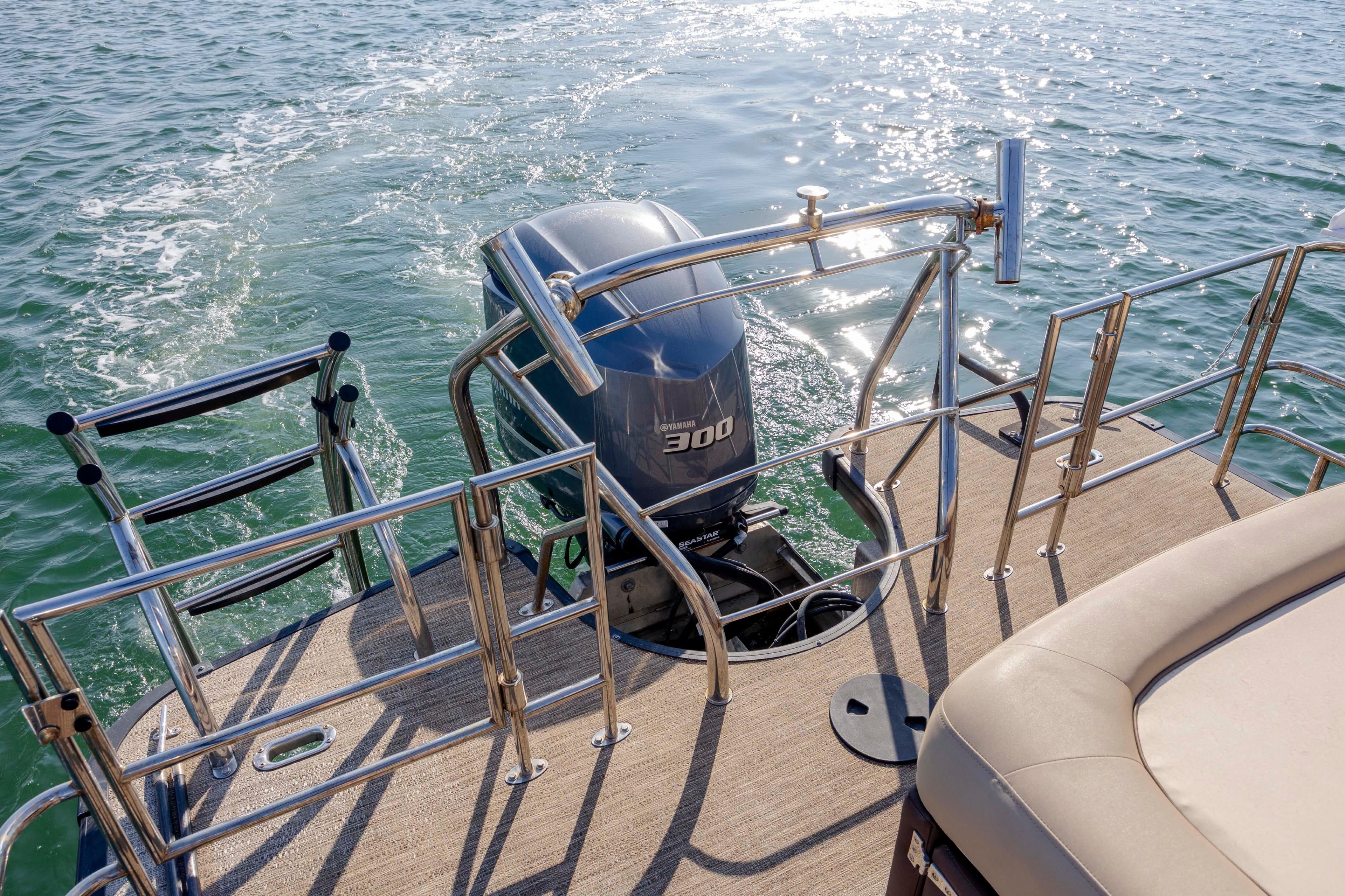 2022 Godfrey Monaco 255 SFL boat with powerful outboard motor on water.