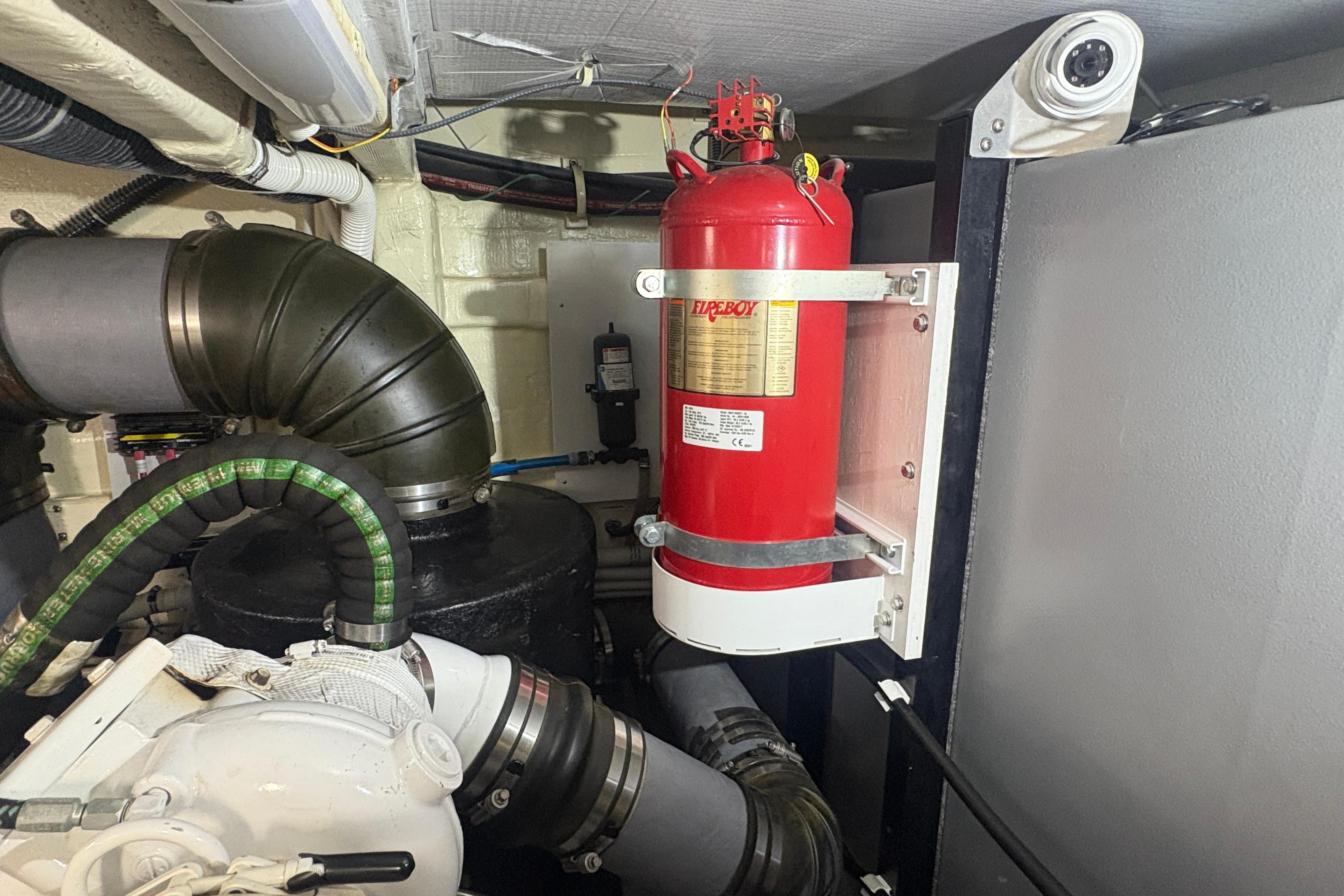 Engine room of 2018 Carver C52 Coupe with fire extinguisher and ventilation system.