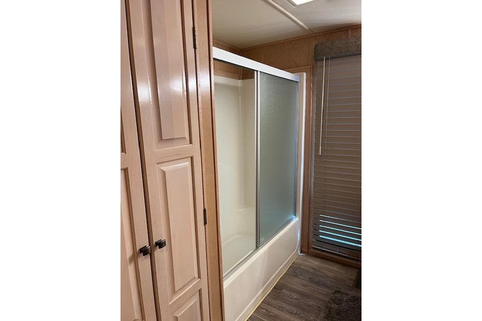 Bathroom with sliding glass shower doors in a 1995 Sumerset 19.5 x 95 houseboat.