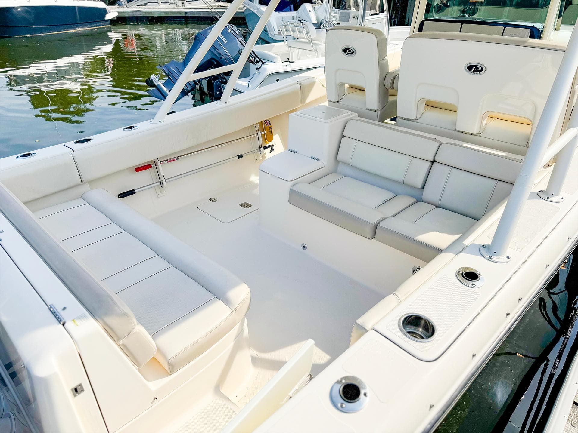 2014 Pursuit ST 310 Sport boat interior with white seating and cup holders.