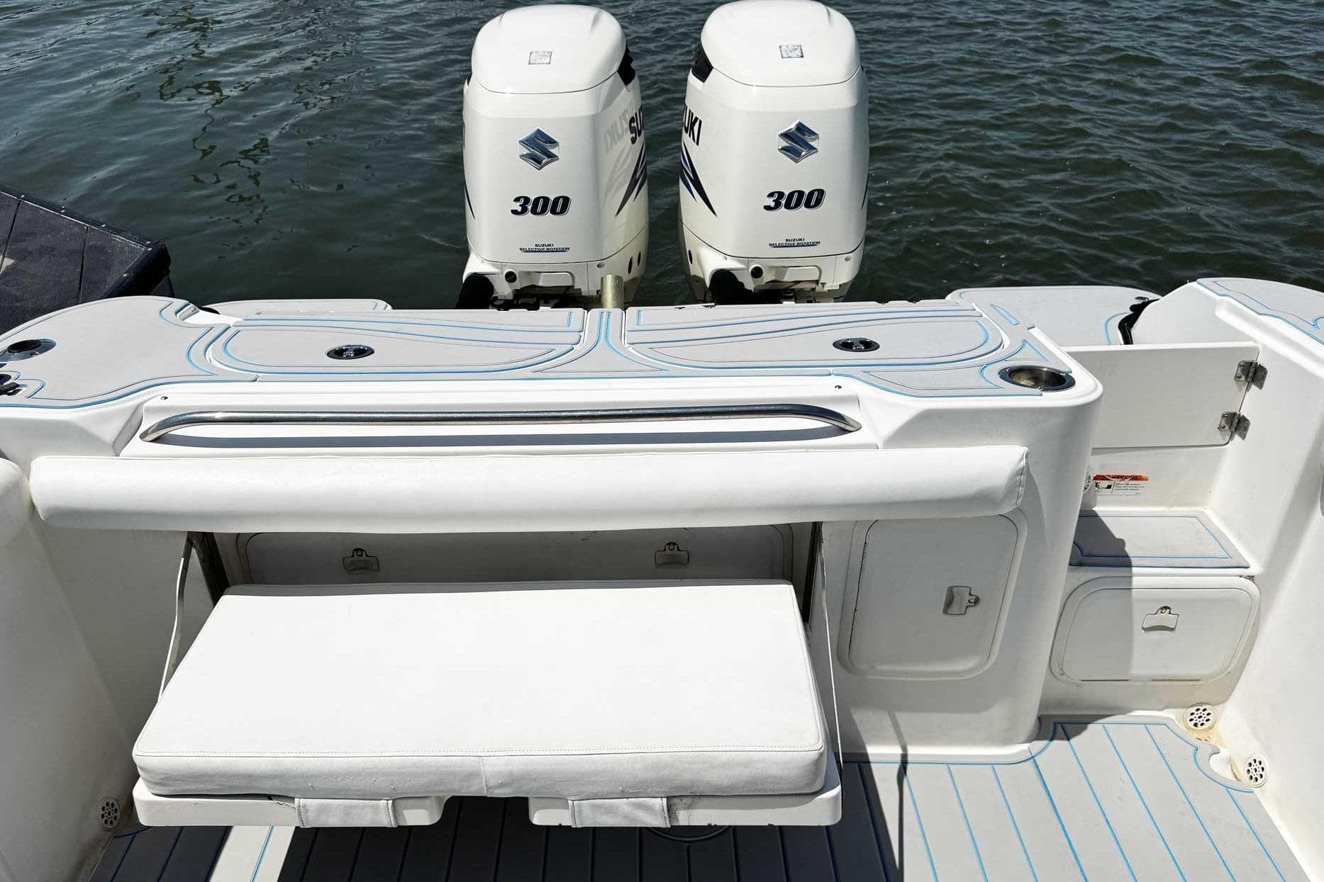 2005 Wellcraft 32 CCF boat with dual Suzuki 300 engines on water.