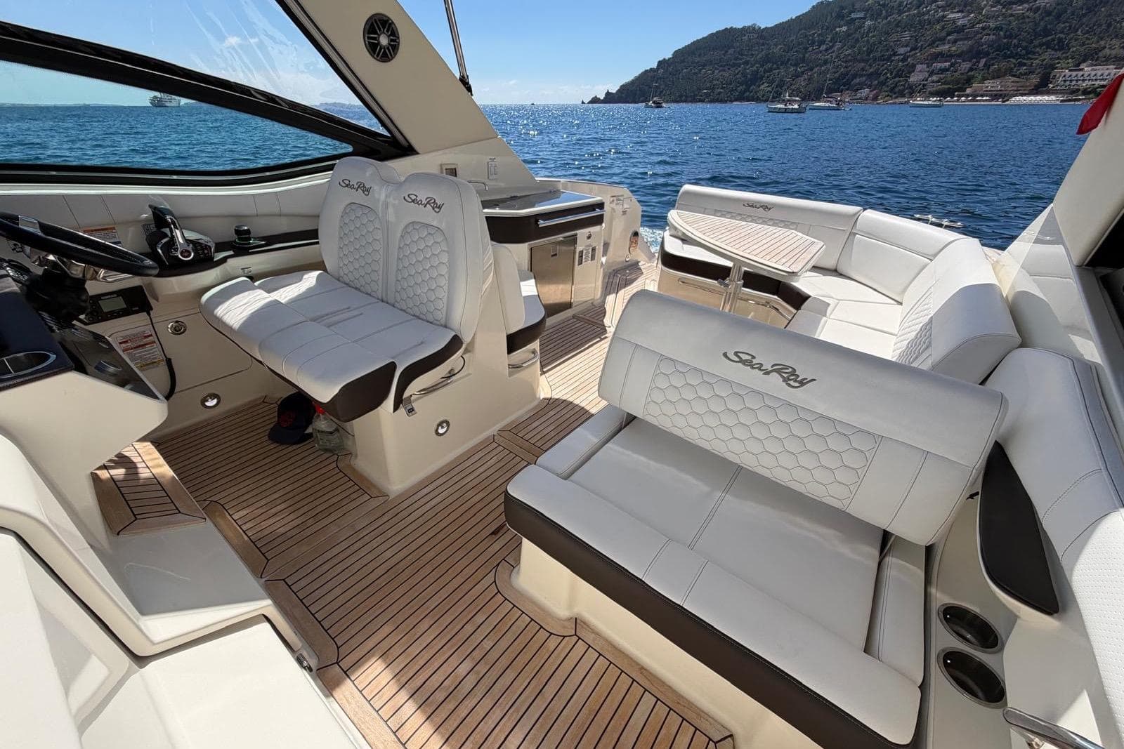 Luxurious 2022 Sea Ray Sundancer 320 yacht interior with elegant seating and scenic ocean view.