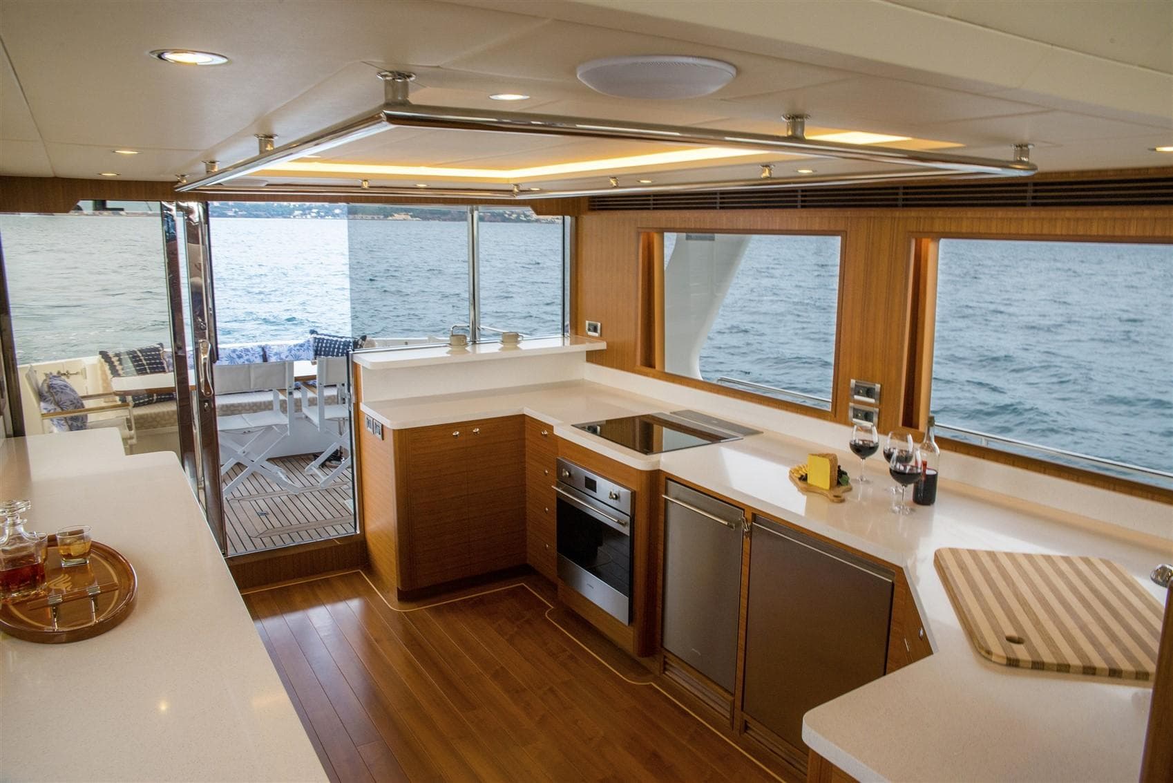 Luxurious kitchen interior of 2027 Outer Reef Yachts 640 Azure Motoryacht with ocean view.