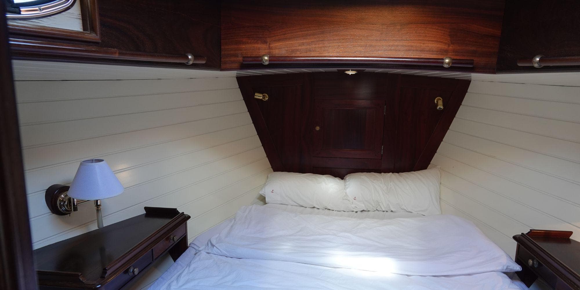 Cozy cabin interior of 2004 Joubert-Nivelt TM 52 yacht with bed and wooden furnishings.