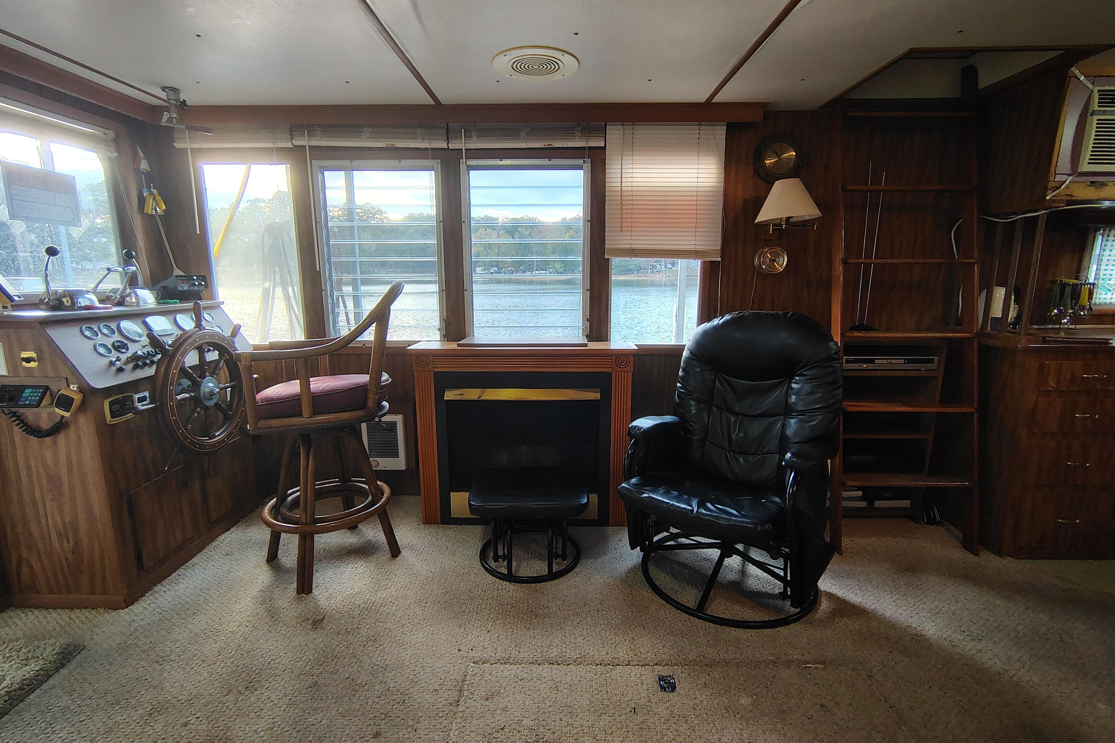 Interior of a 1981 Lazy Days 50 boat with steering wheel and seating area.