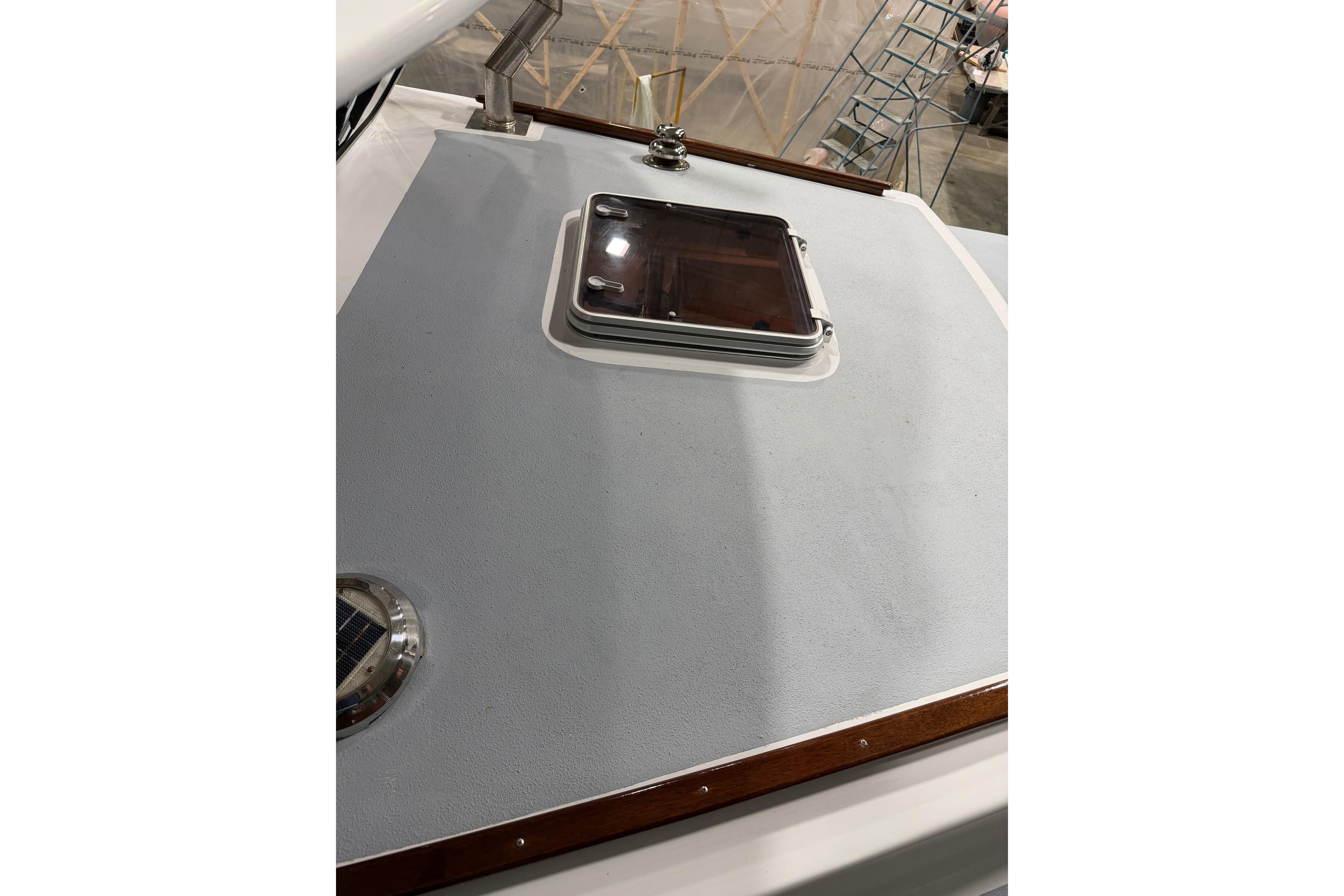 2022 Covey Island 38 Lobster Yacht deck with hatch and wooden trim.