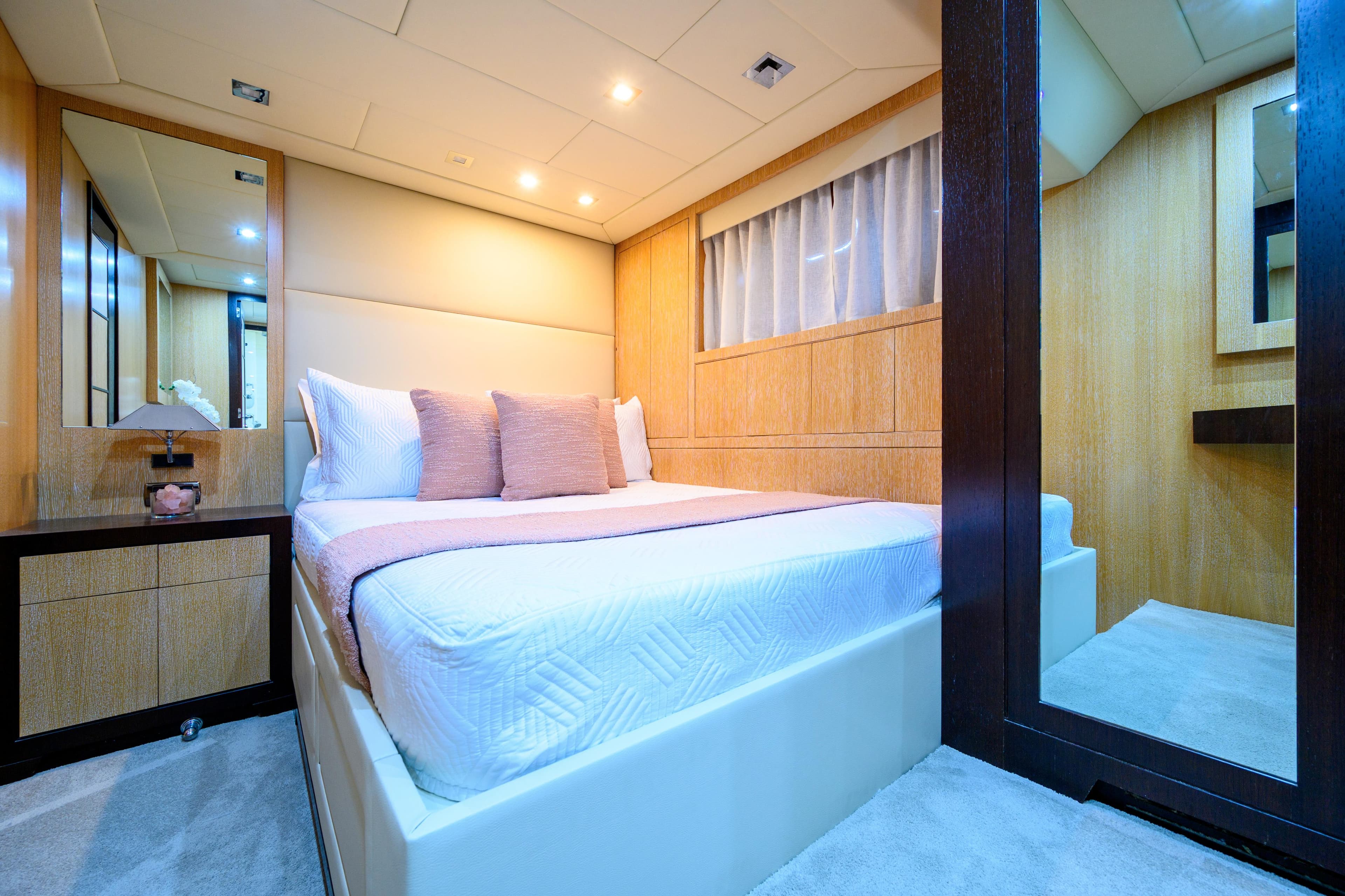 Luxurious bedroom interior of 2007 Mangusta 80 yacht with modern decor and ambient lighting.