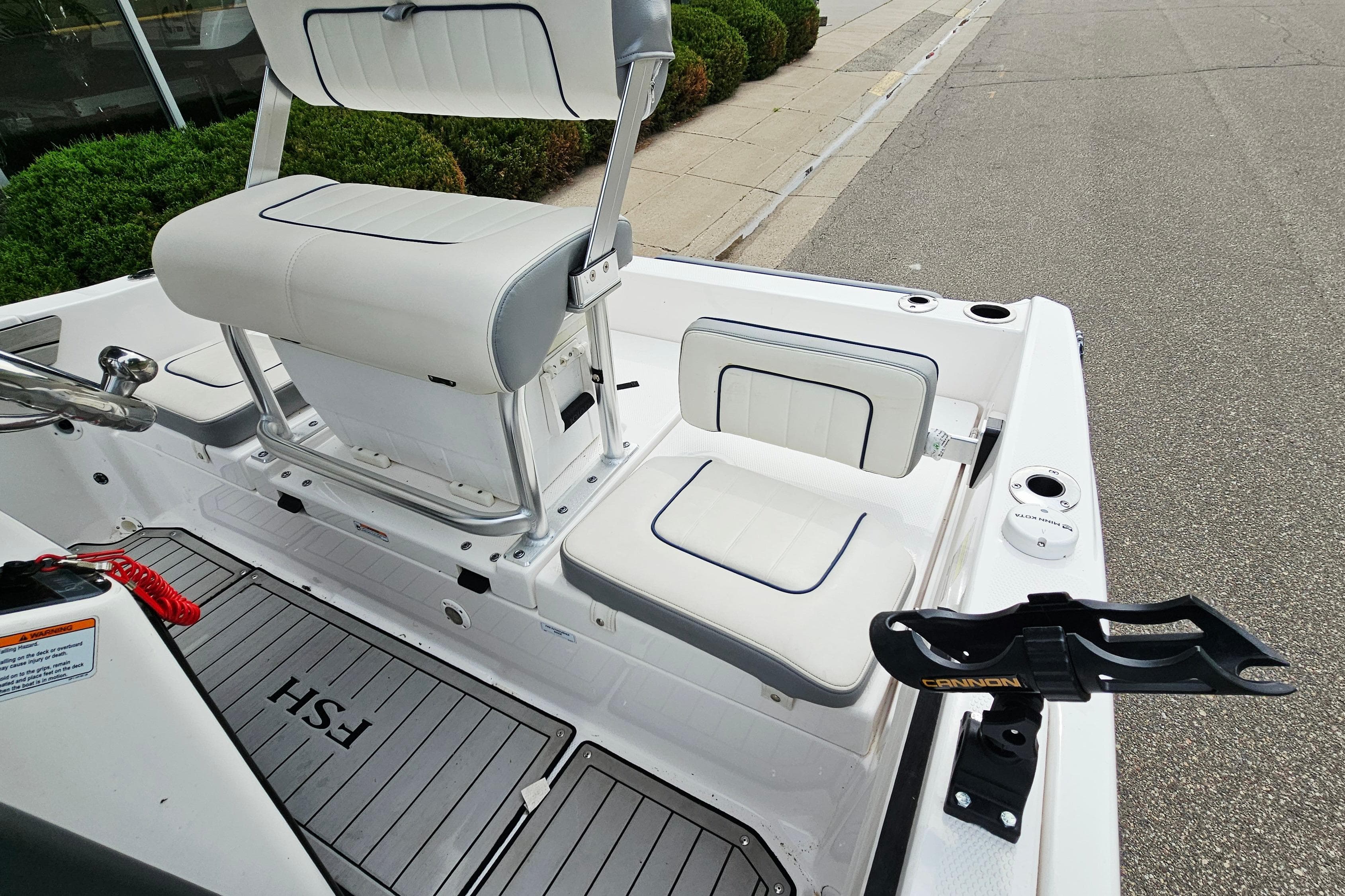 2020 Yamaha Boats 195 FSH Sport interior with white seating and rod holder.
