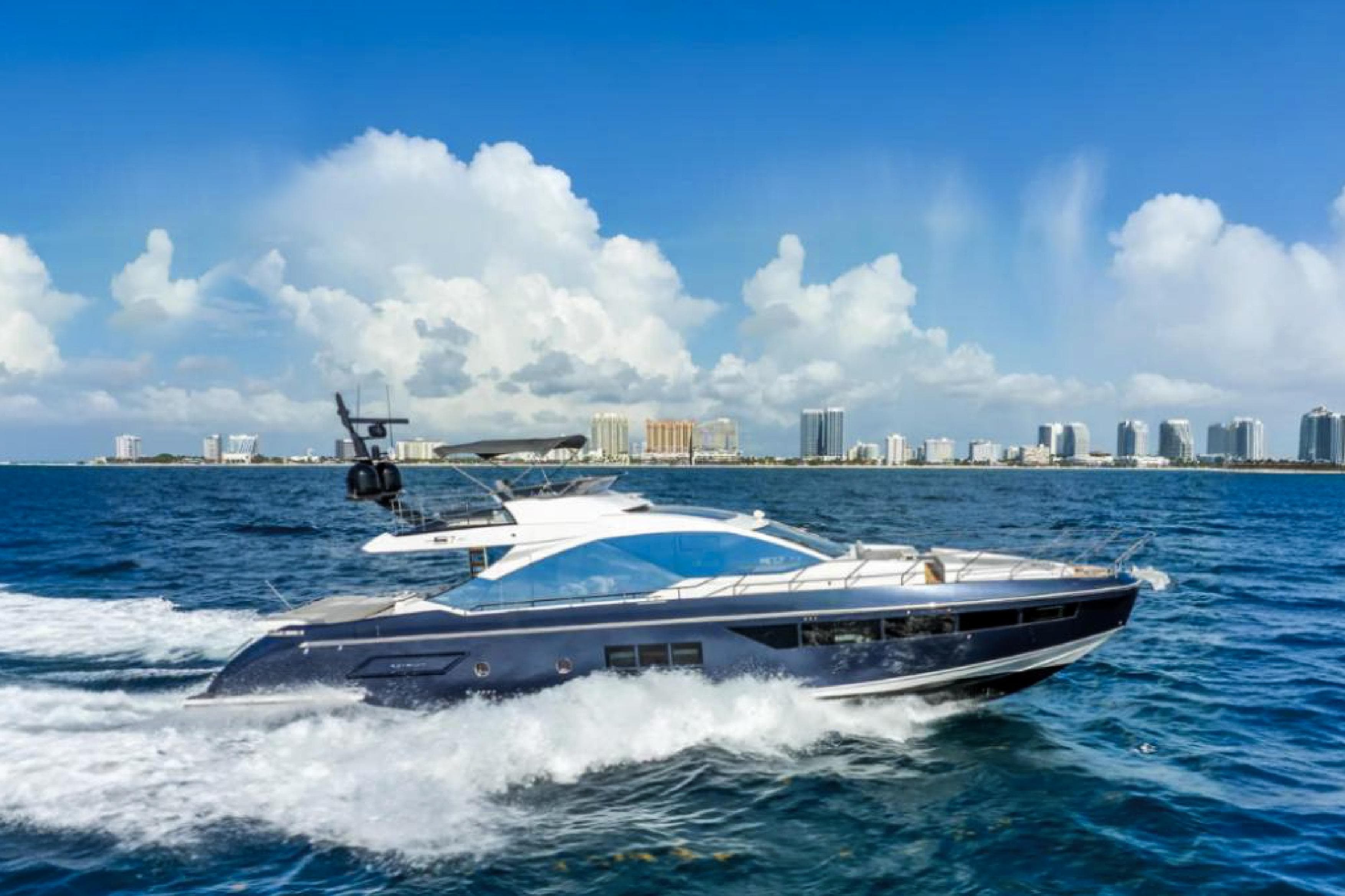 2019 Azimut S7 yacht cruising on blue ocean with city skyline backdrop.