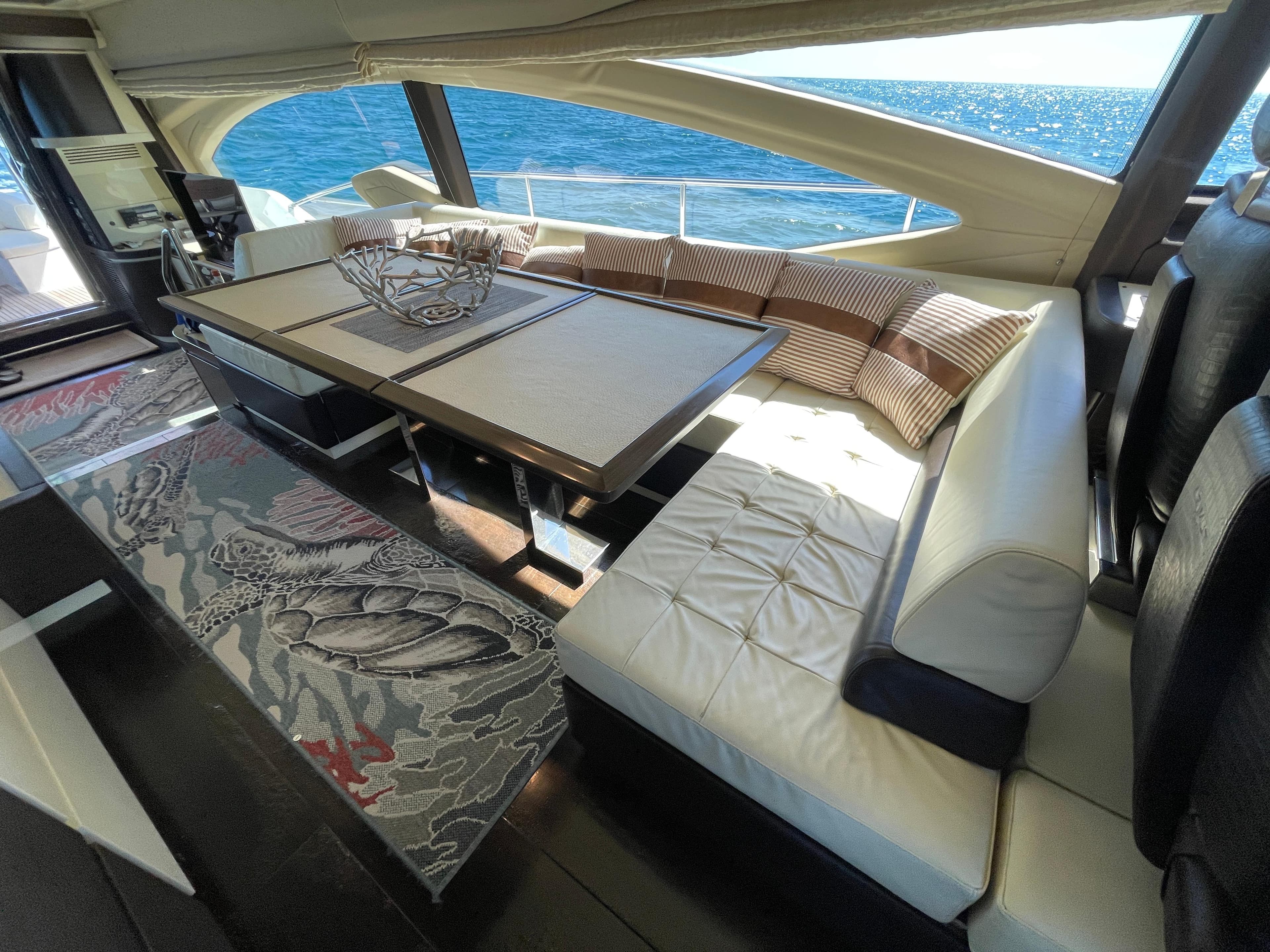 Luxurious interior of a 2014 Azimut 70 yacht with elegant seating and ocean view.