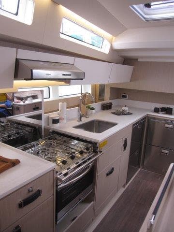 Modern kitchen in 2024 Jeanneau 55 yacht with stainless steel appliances.