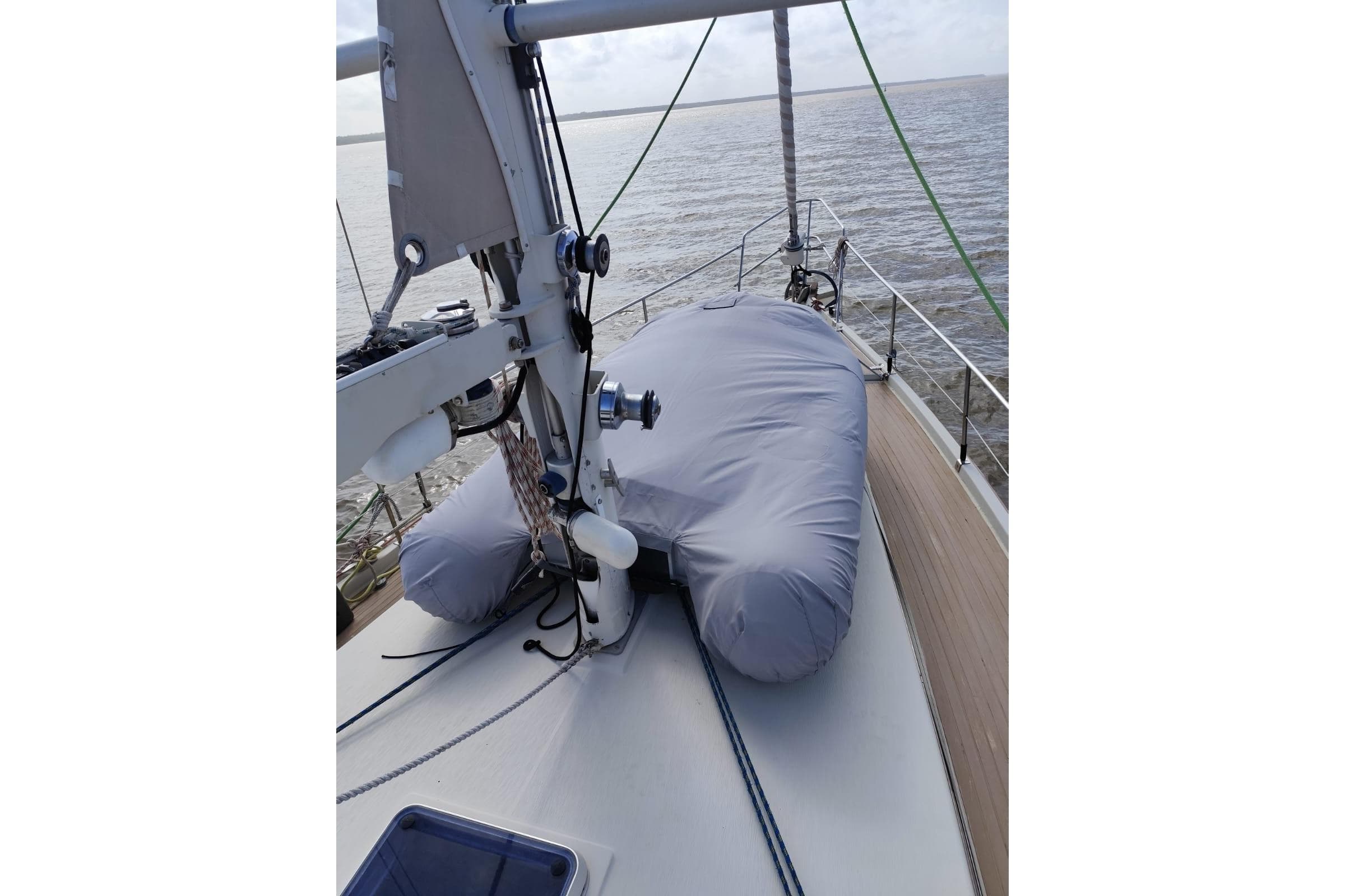 1993 Amel Santorin Sloop deck with covered equipment, sailing on calm waters.