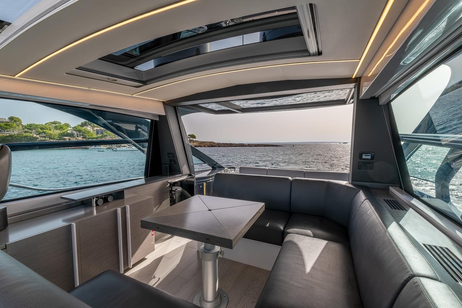 Luxurious interior of 2017 Pershing 5x yacht with ocean view and modern seating.