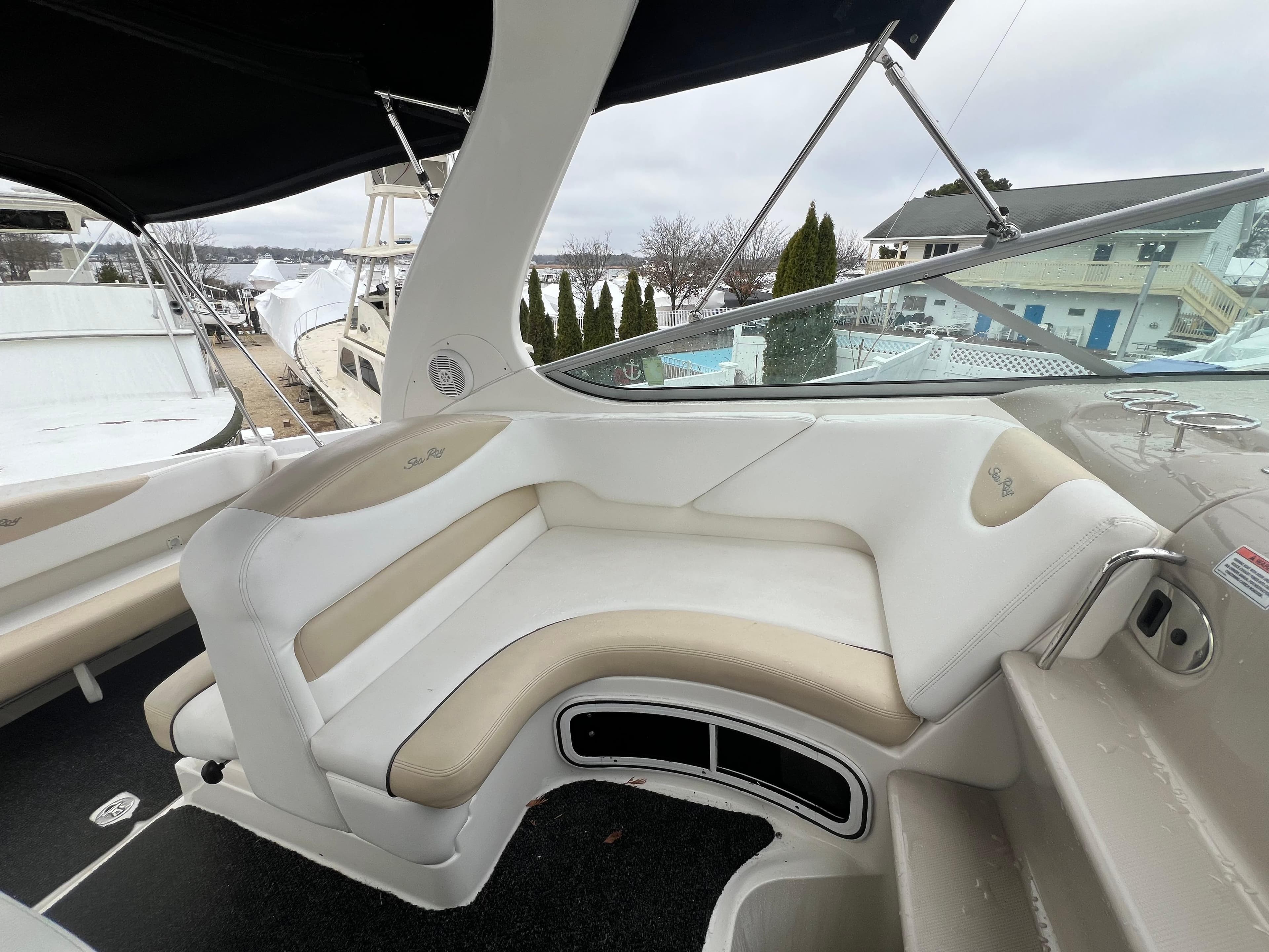 2008 Sea Ray 280 Sundancer boat interior with white and beige seating.