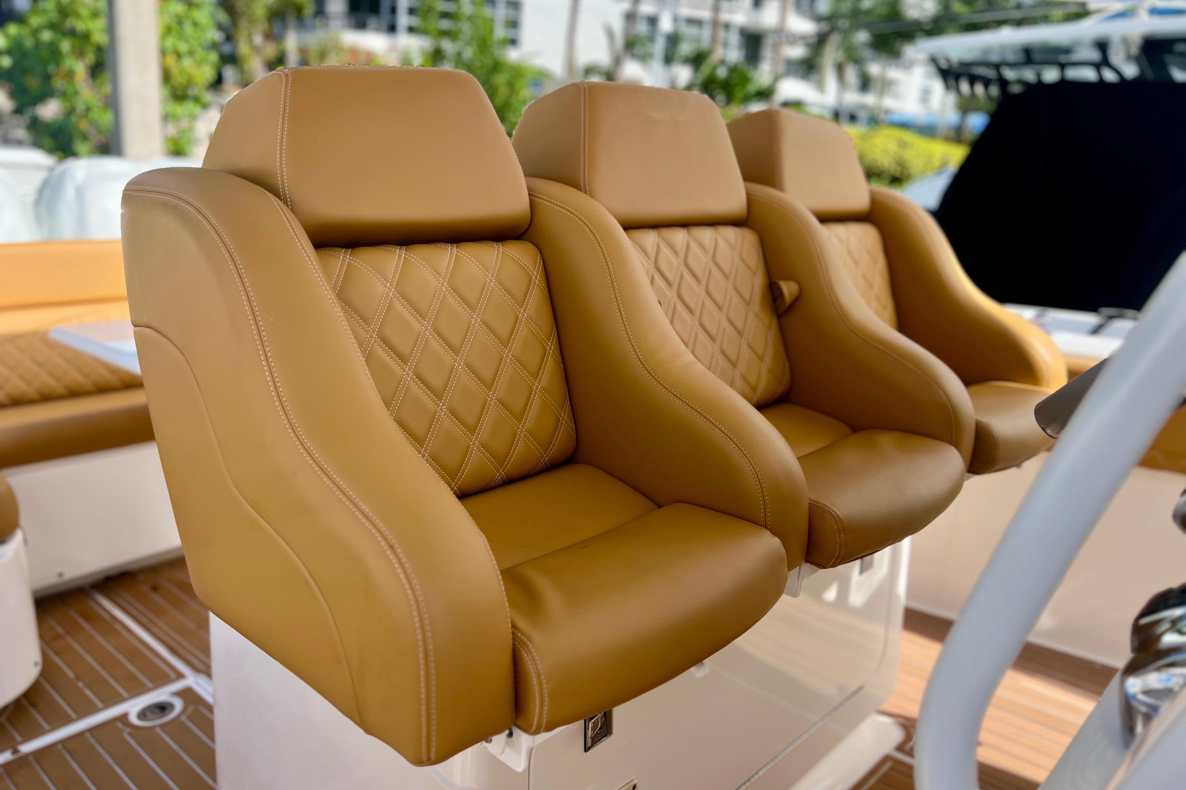 Luxurious tan leather seats on a 2011 Deep Impact 36 Open boat.
