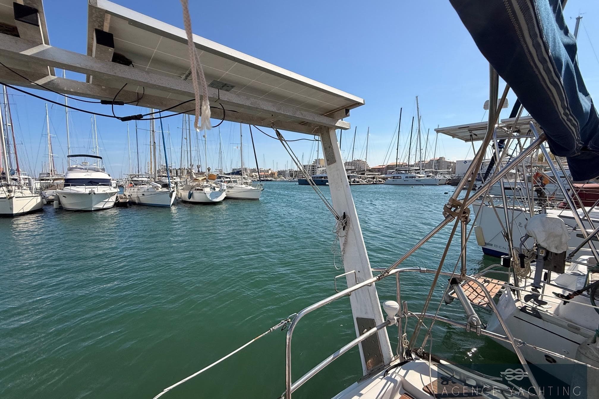 Marina view with Jeanneau Sun Odyssey 39i Performance, 2009, docked among sailboats.