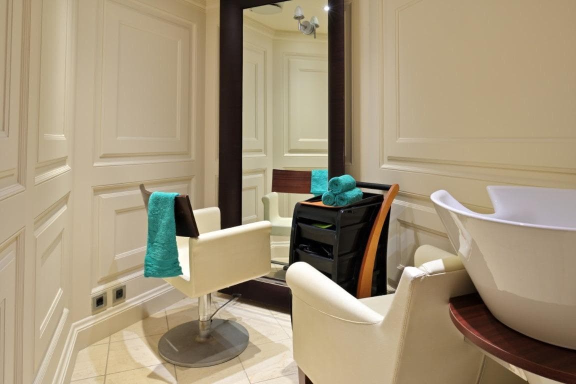 Luxurious salon interior on Canadian Vickers CHRISTINA O yacht, featuring elegant styling chair and mirror.