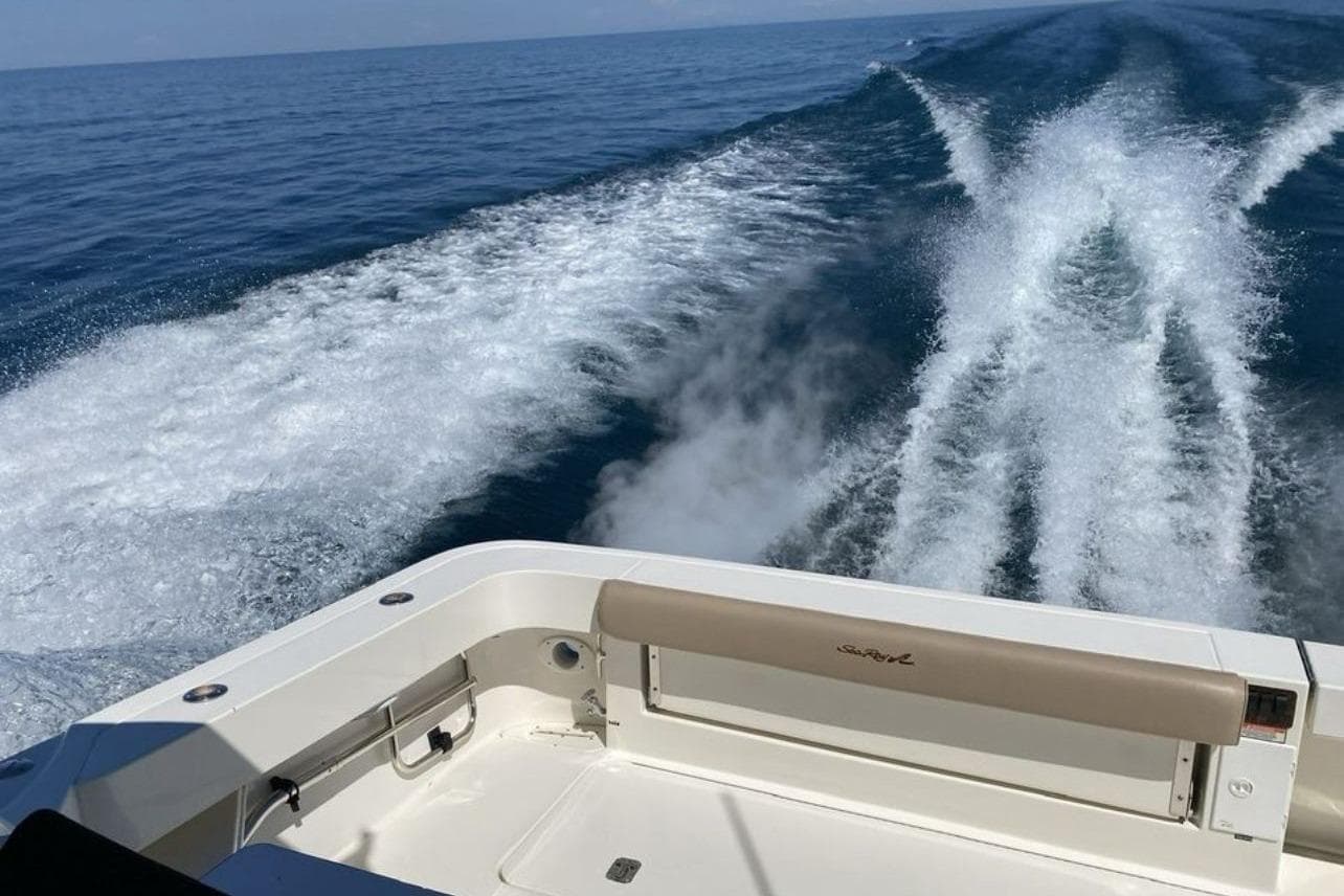 2000 Sea Ray 340 Amberjack cruising, leaving a wake on the open sea.