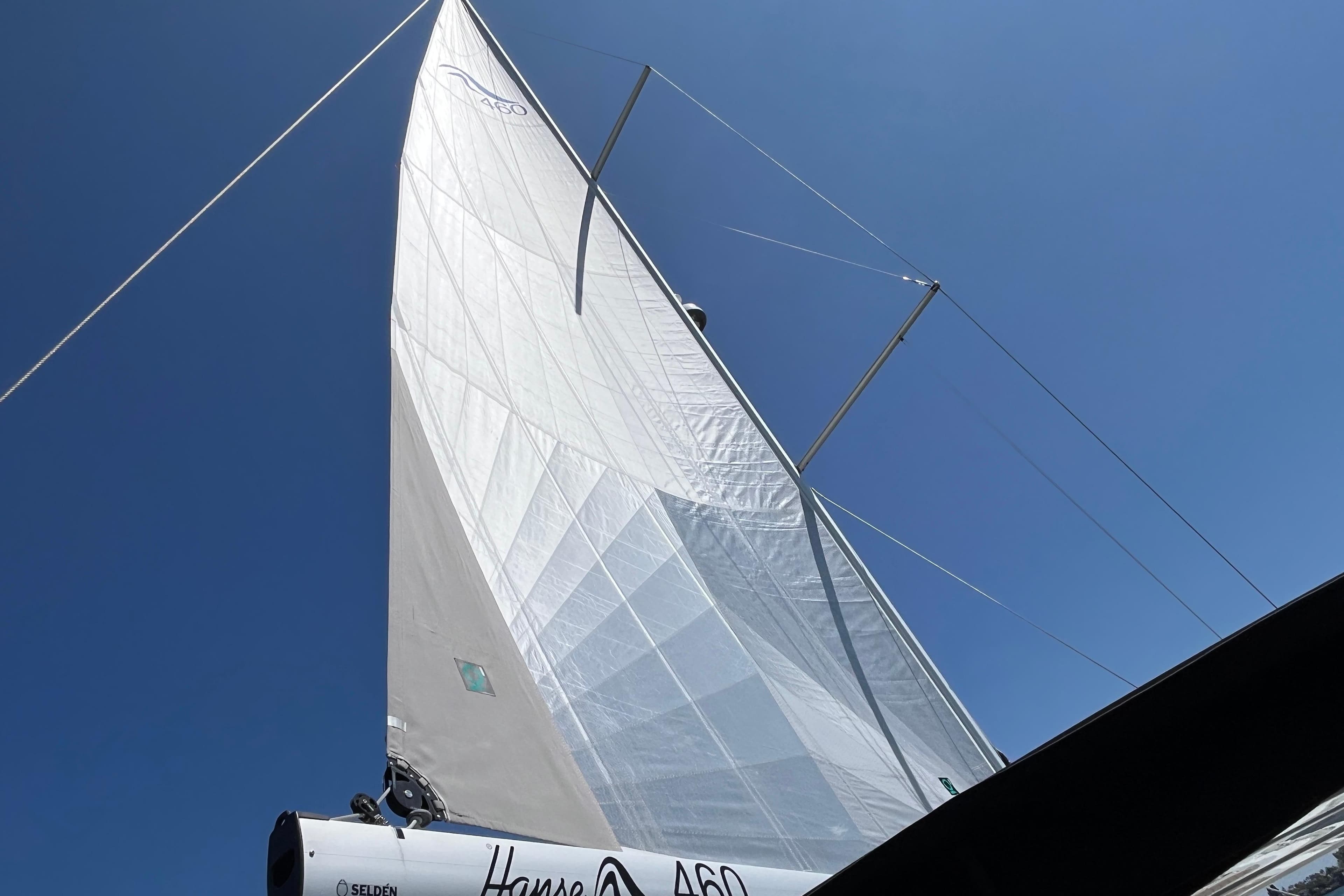 Sailing yacht Hanse 460, 2025 model, with sails unfurled against a clear blue sky.