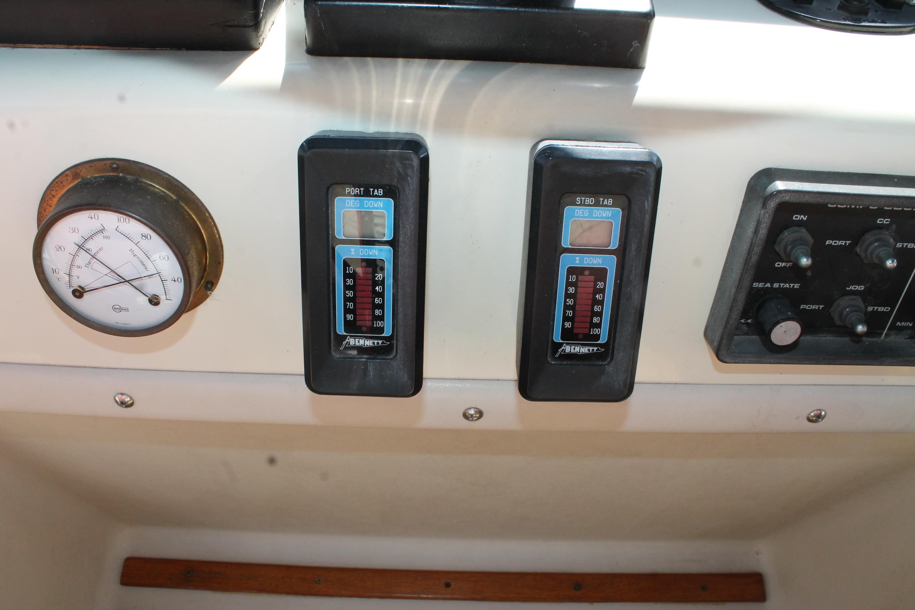Control panel of a 1987 Chris-Craft 427 Catalina boat with gauges and switches.