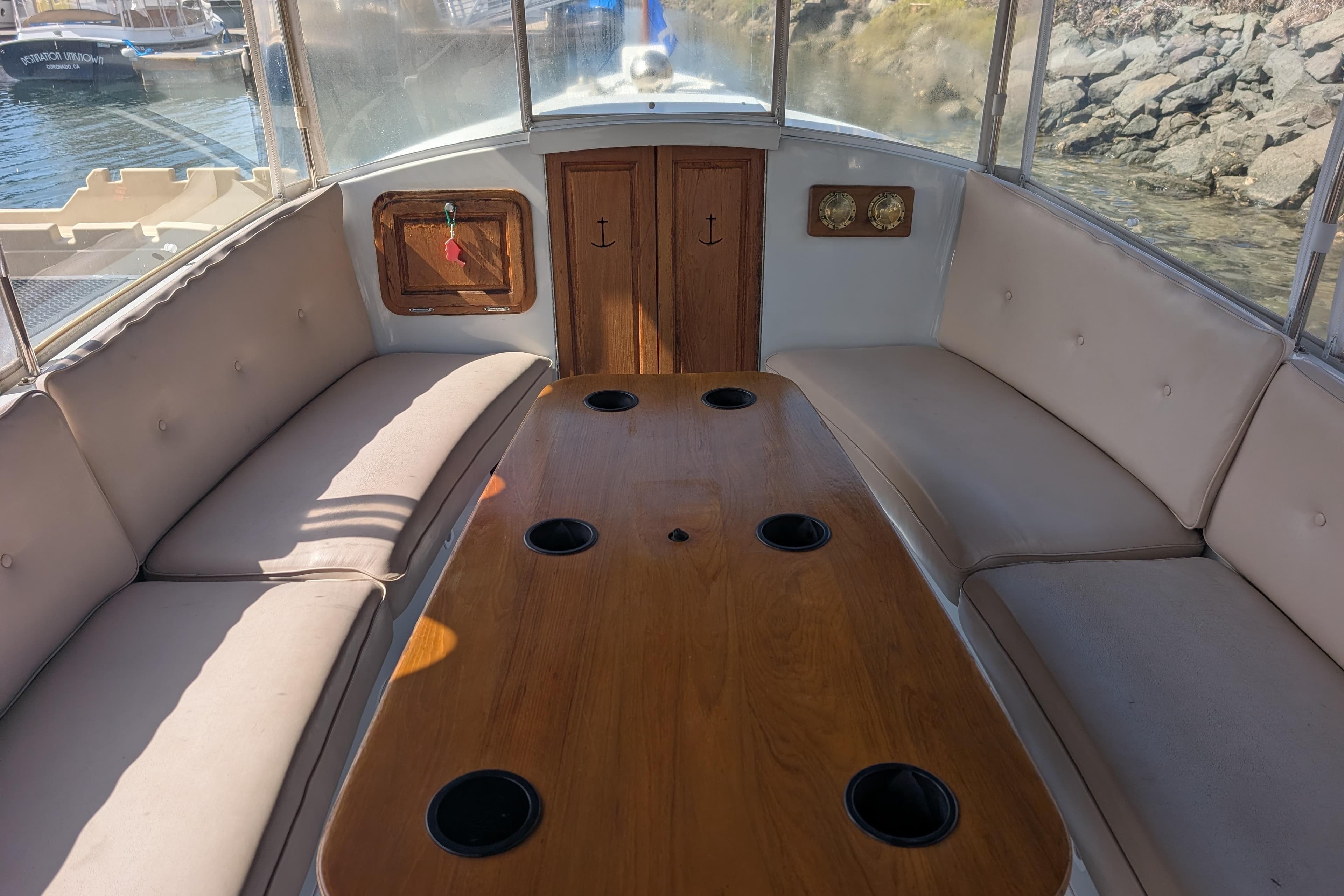 Interior of 2007 Duffy Cuddy Cabin 22 boat with cushioned seating and wooden table.