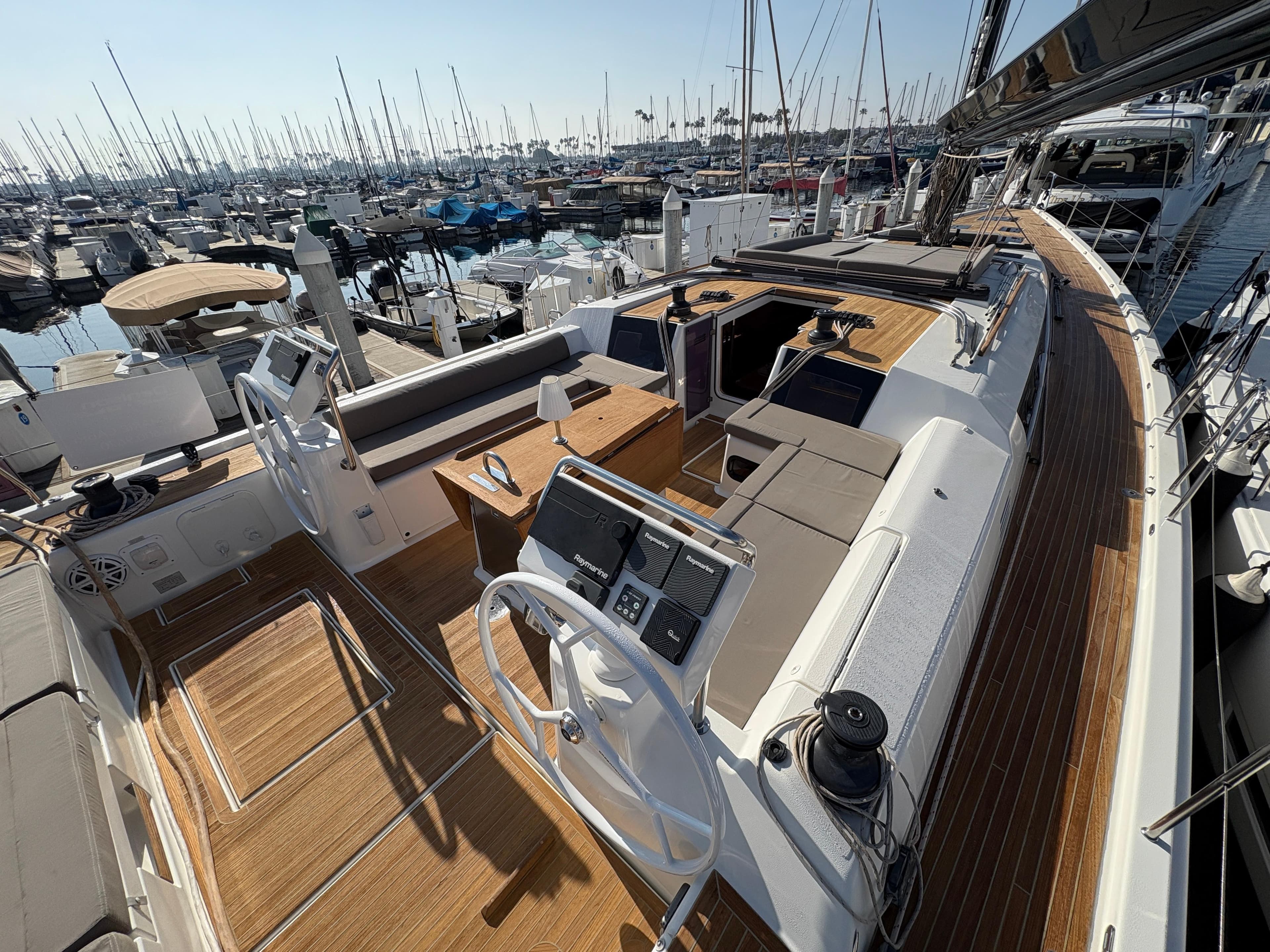 Luxurious 2018 Dufour 560 Exclusive yacht with spacious deck and modern helm, docked at marina.