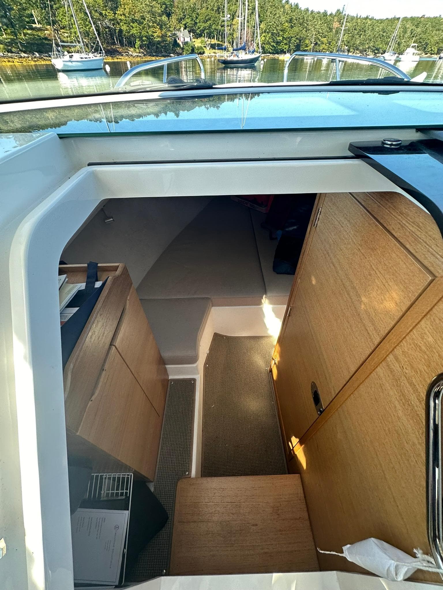 Interior view of 2021 Nimbus W9 boat cabin with wooden furnishings.