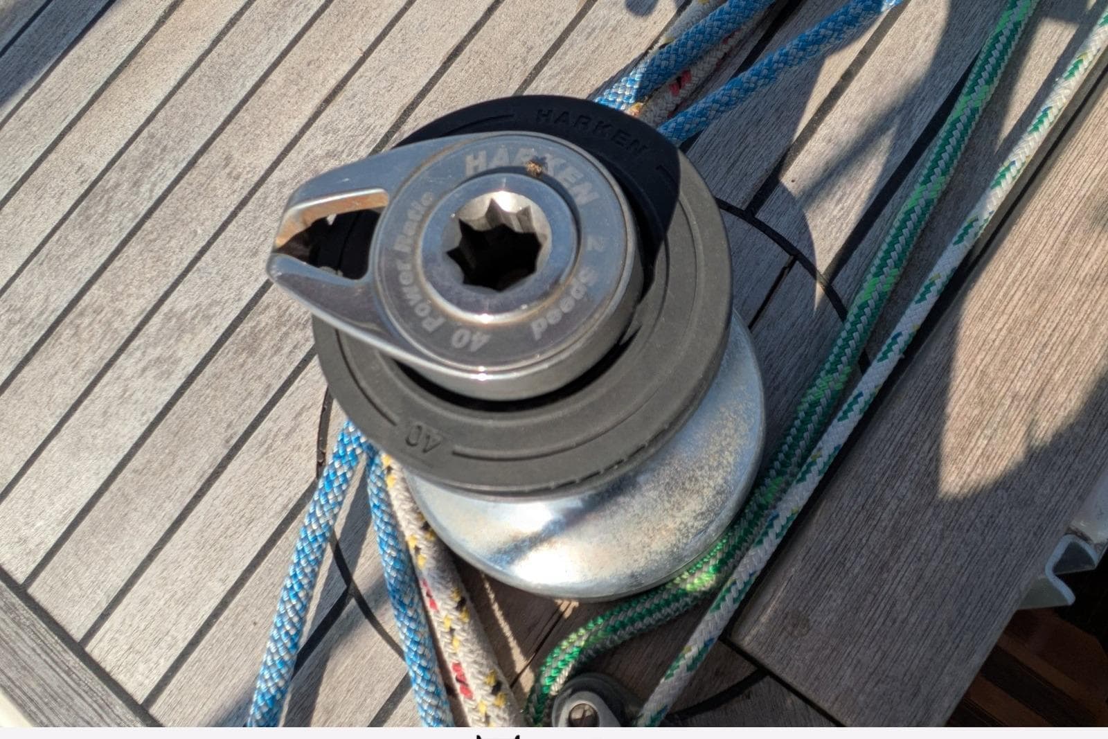 Sailing winch on a 2004 Feeling 44 DI yacht deck with colorful ropes.