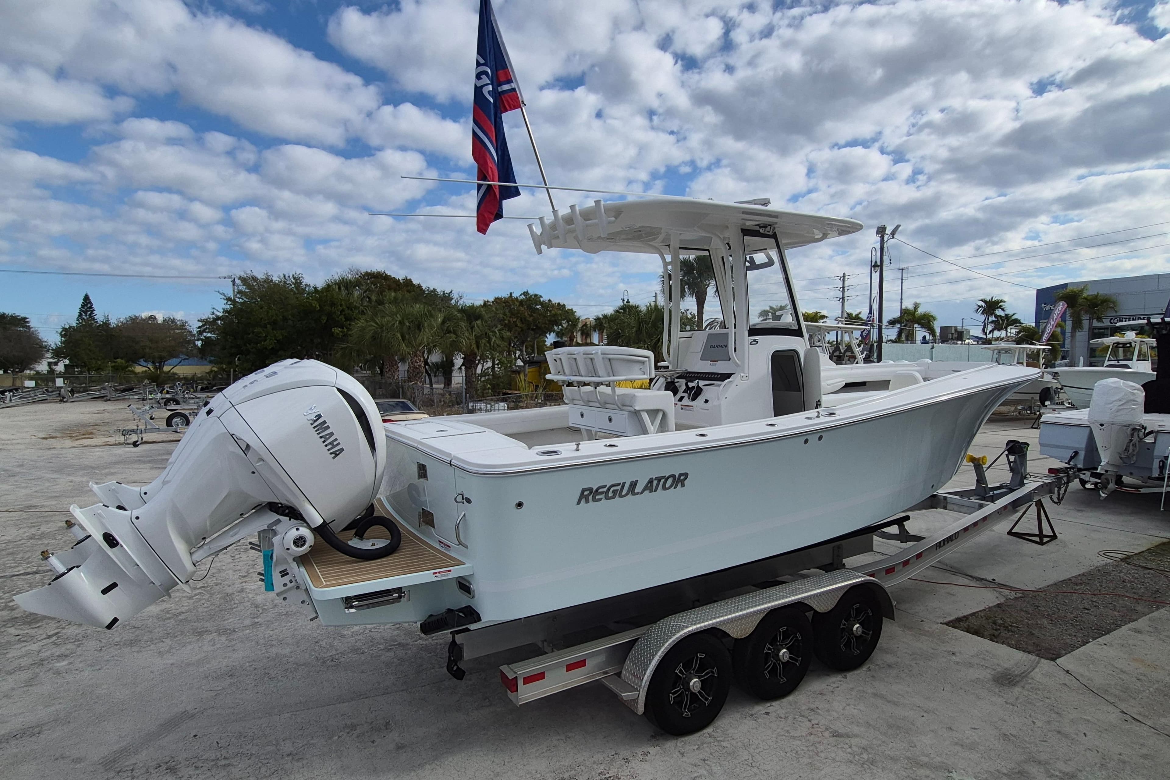 2026 Regulator 25 boat with Yamaha engine on trailer, under cloudy sky.