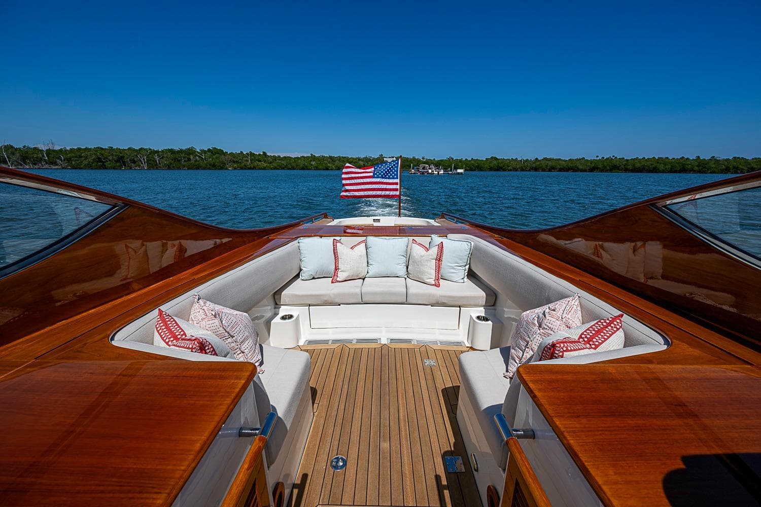 Hinckley Talaria 34R 2017 yacht with elegant seating, American flag, and scenic water view.