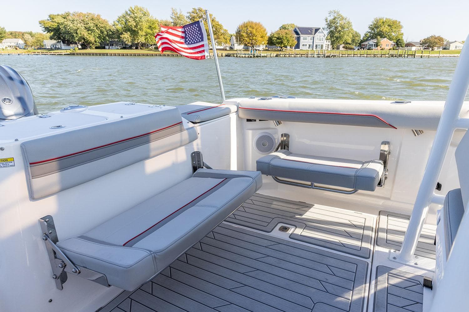 Manufacturer Provided Image: Solara S-250 CW 2025 boat interior with seating, American flag, and scenic waterfront view.
