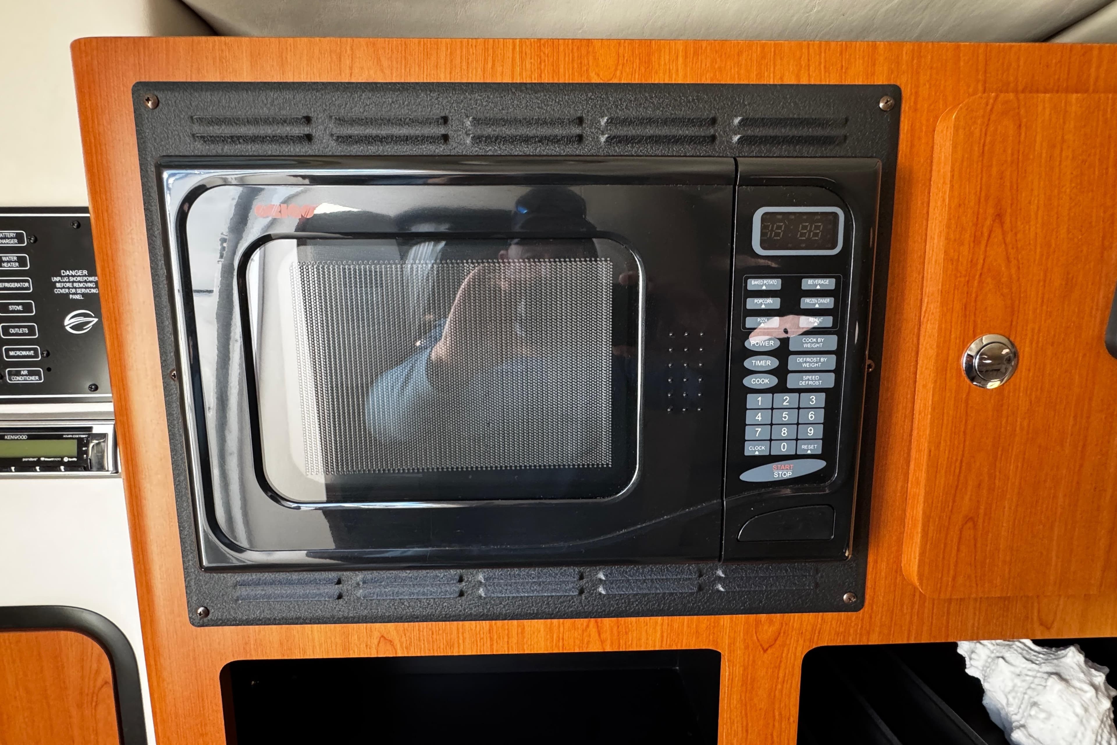 Built-in microwave in 2004 Crownline 250 CR boat interior.