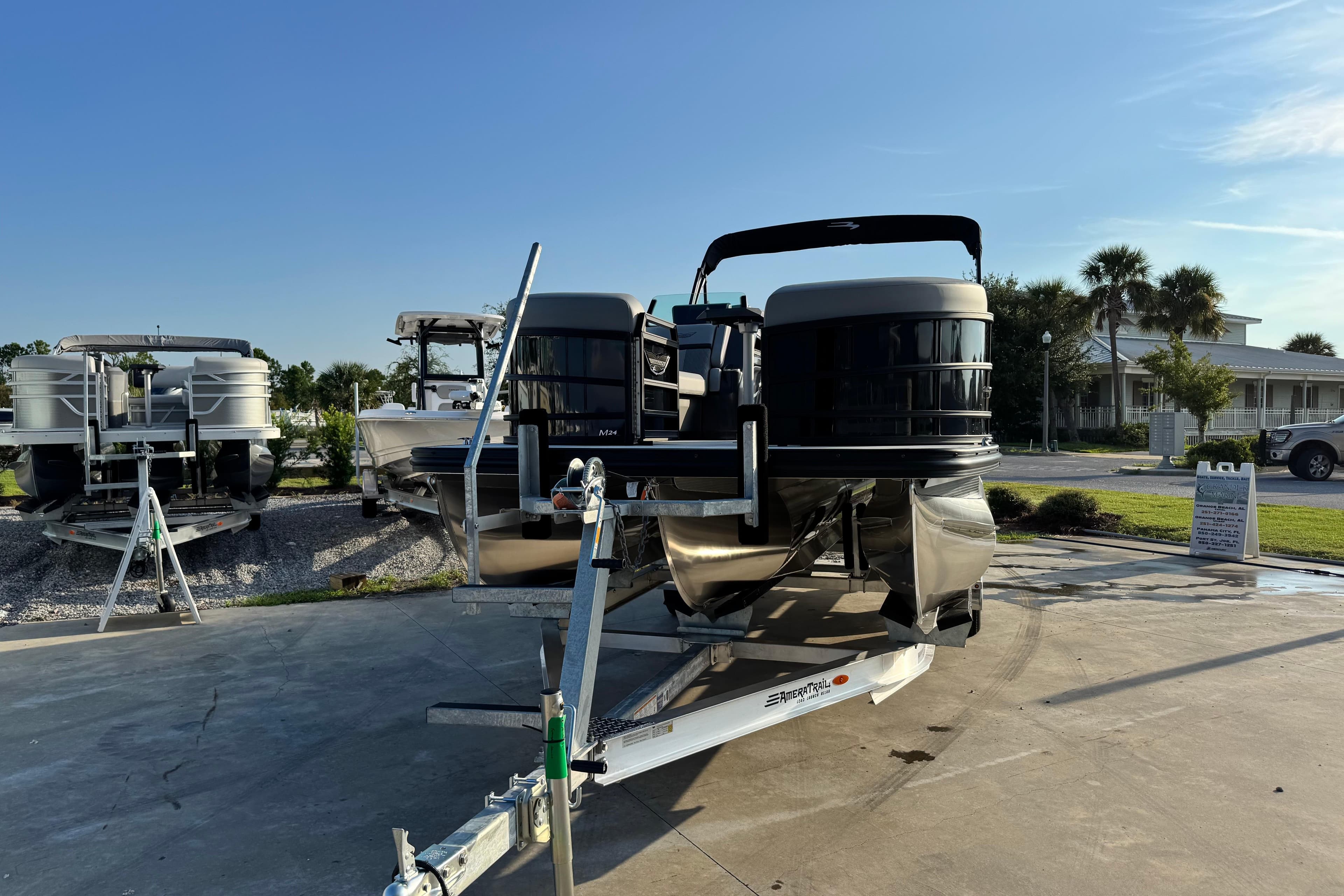 2026 Bennington 24 MSB pontoon boat on trailer, sunny outdoor setting.