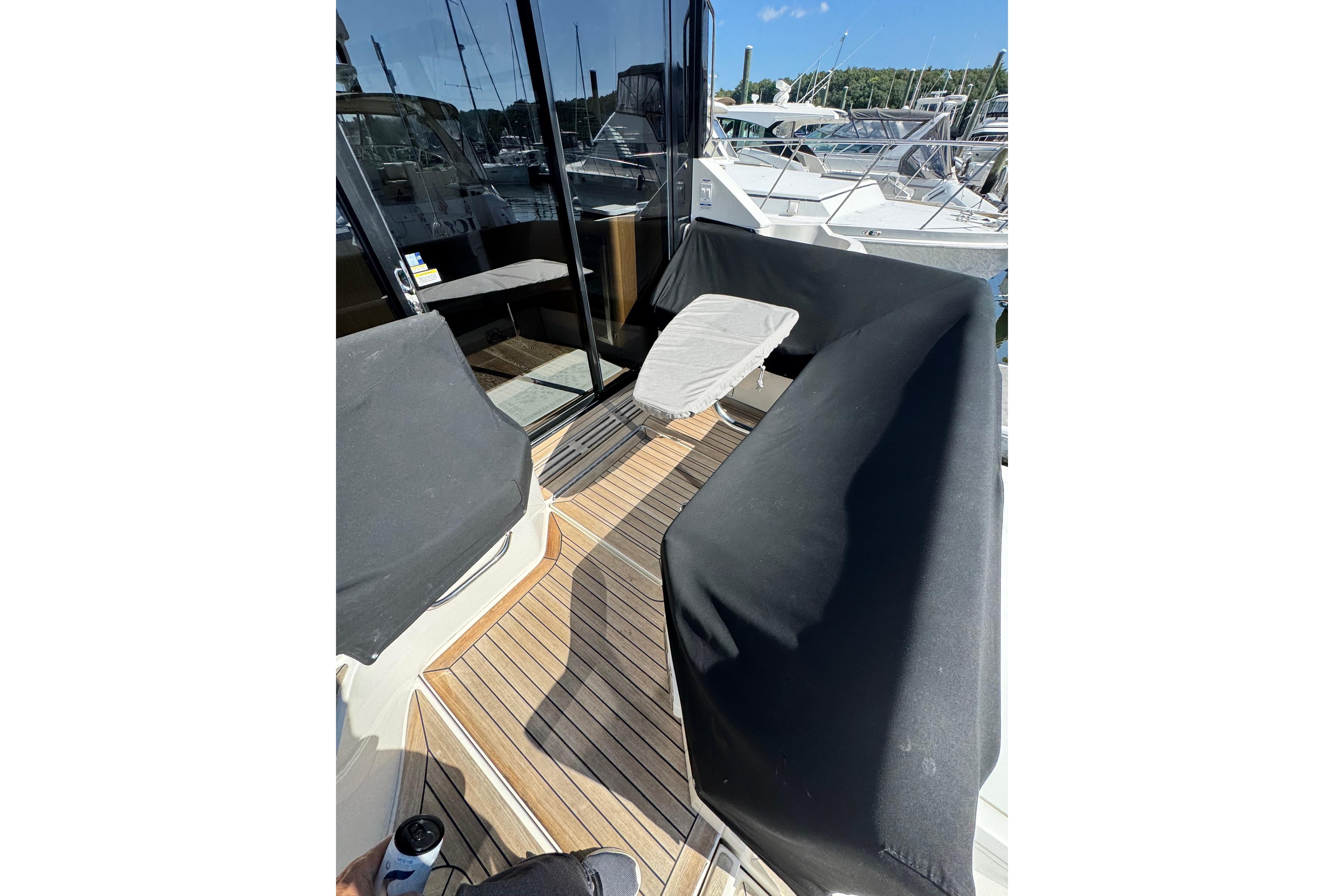 2017 Sea Ray Sundancer 460 yacht deck with covered seating and table.
