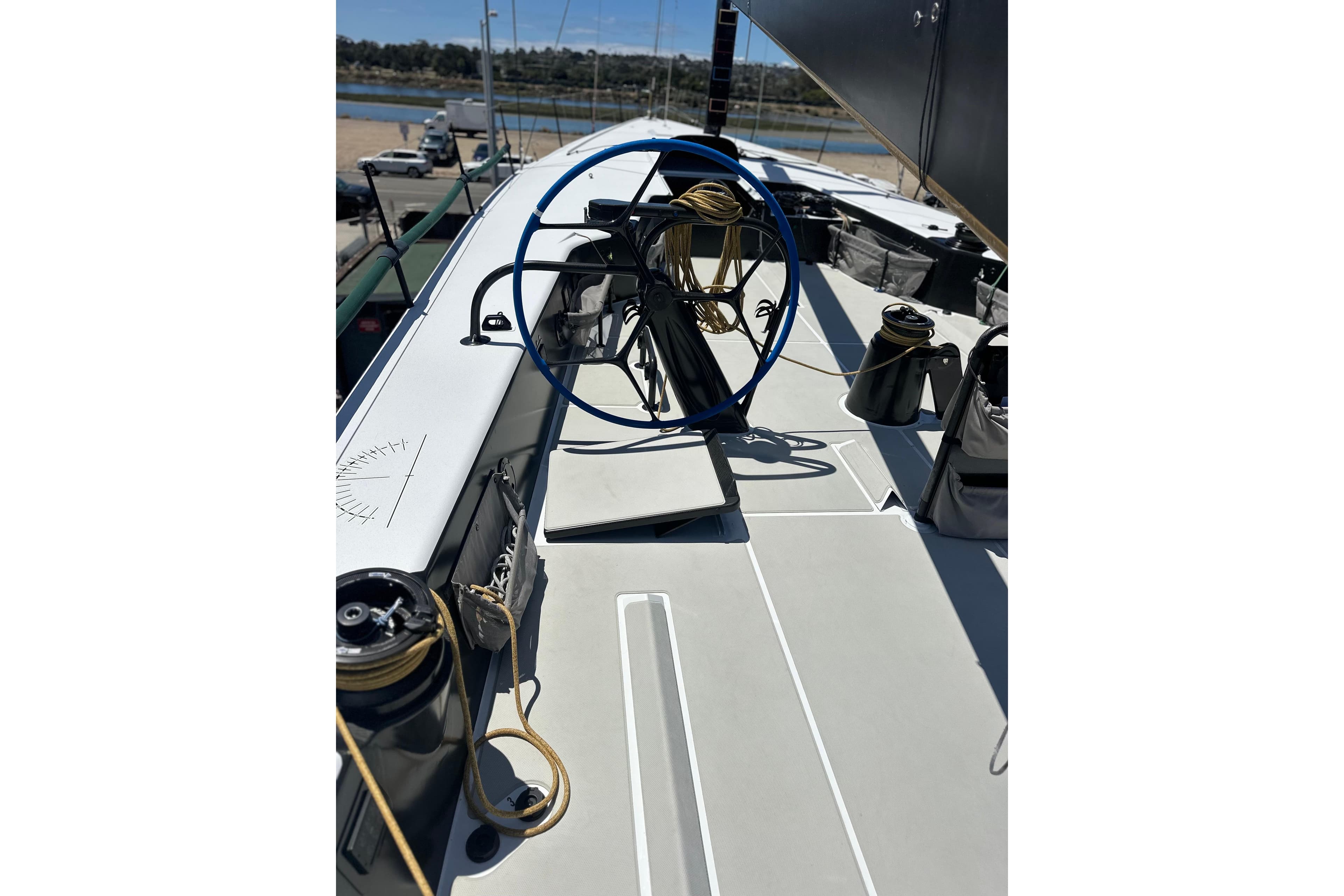 Sailing yacht deck of 2018 Botin 56, featuring winches and steering wheel.