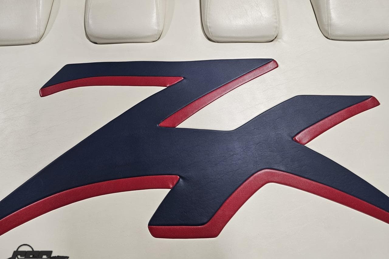 Donzi 33 ZX 2000 logo on white leather upholstery with red and blue accents.