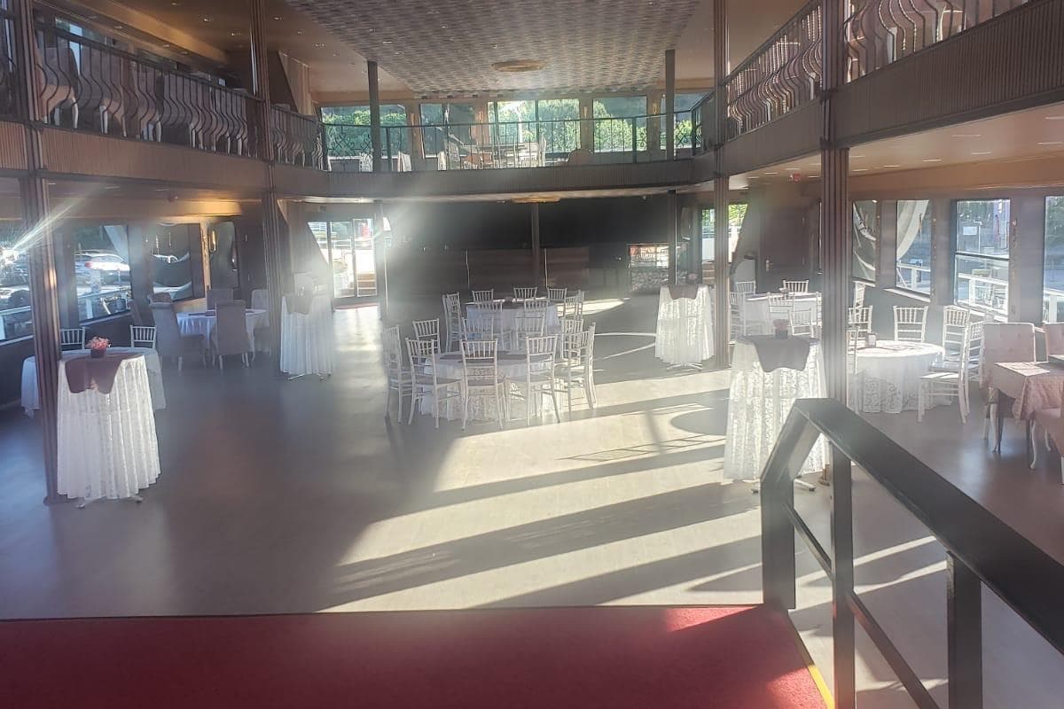 Spacious interior of Custom-Craft 2025 restaurant vessel, elegantly set for dining.