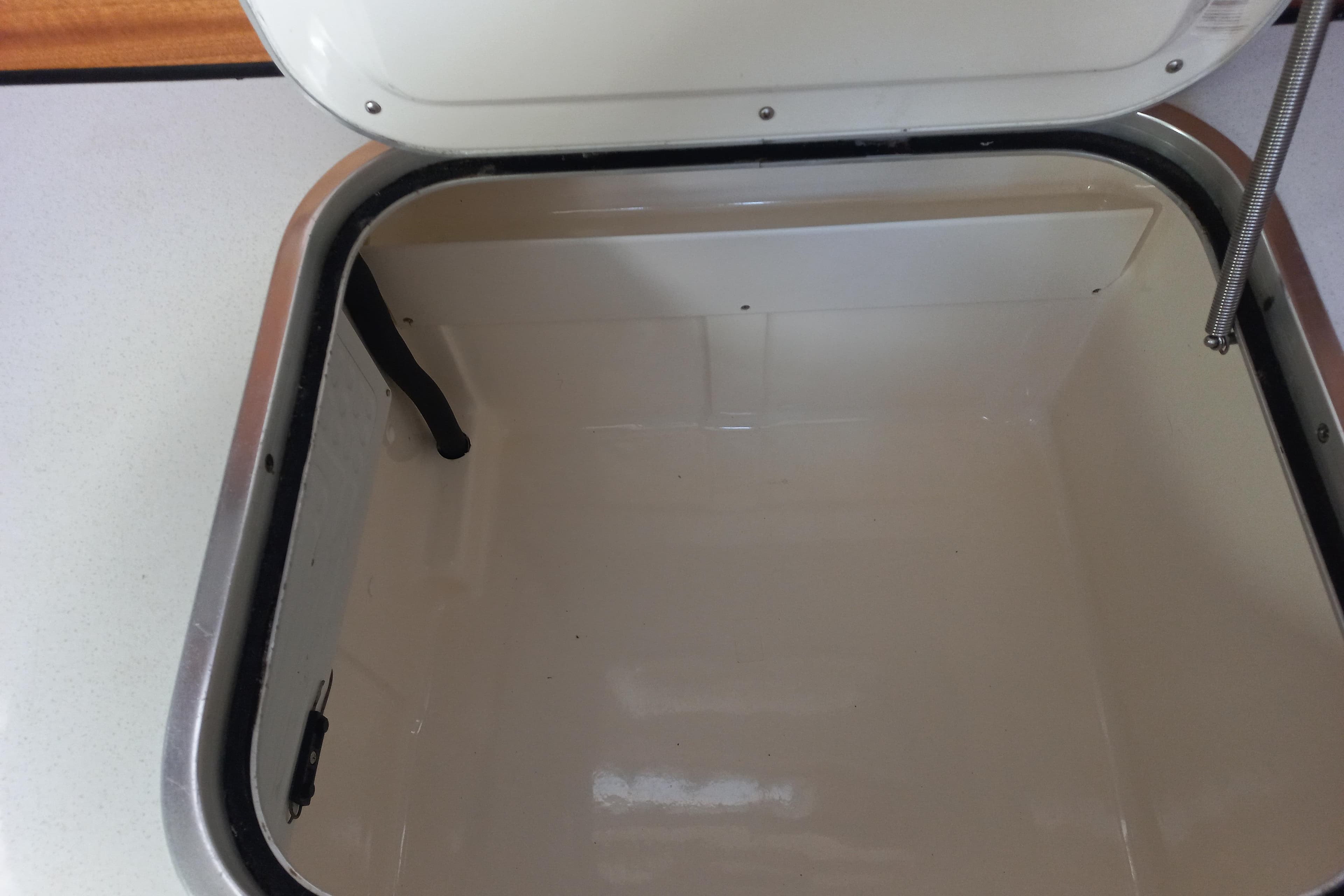 Open storage compartment on a 1999 Bavaria 38 Ocean yacht.