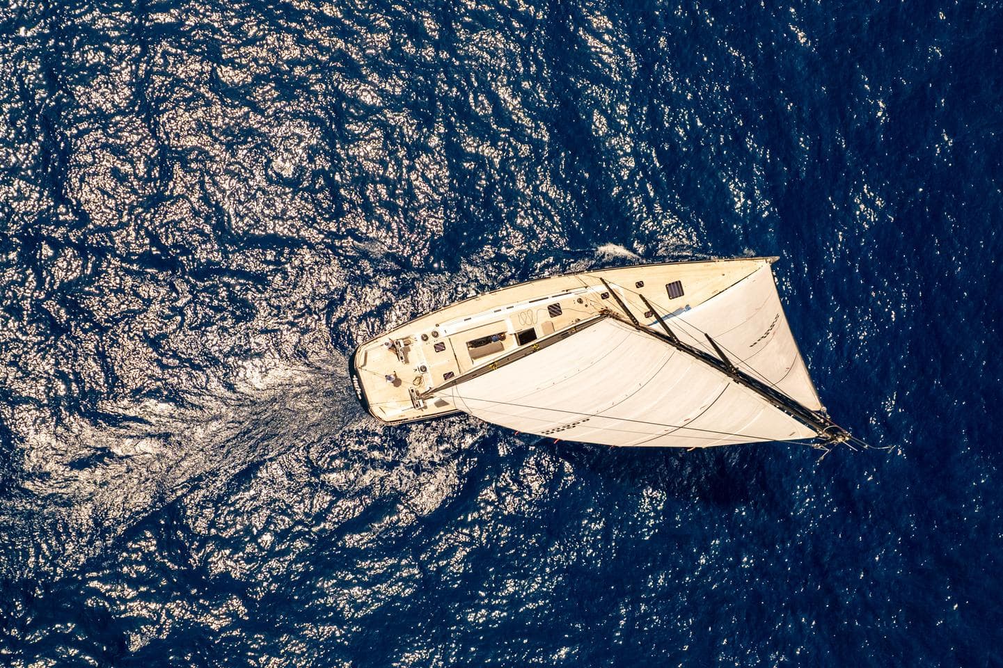Aerial view of 2013 Nautor Swan 80 FD sailing on deep blue ocean.