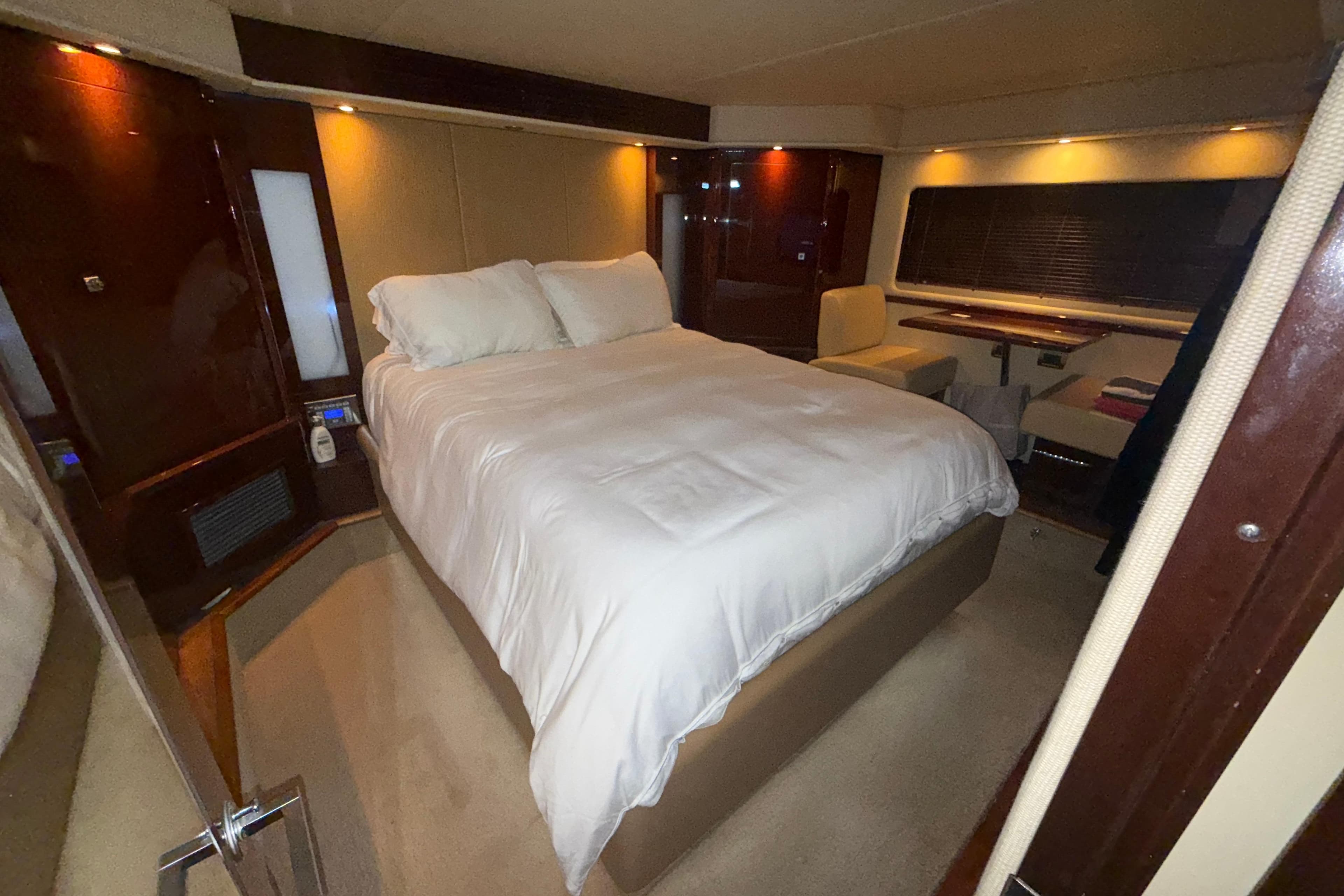 Luxurious bedroom interior of 2008 Sea Ray 55 Sundancer yacht with elegant furnishings.