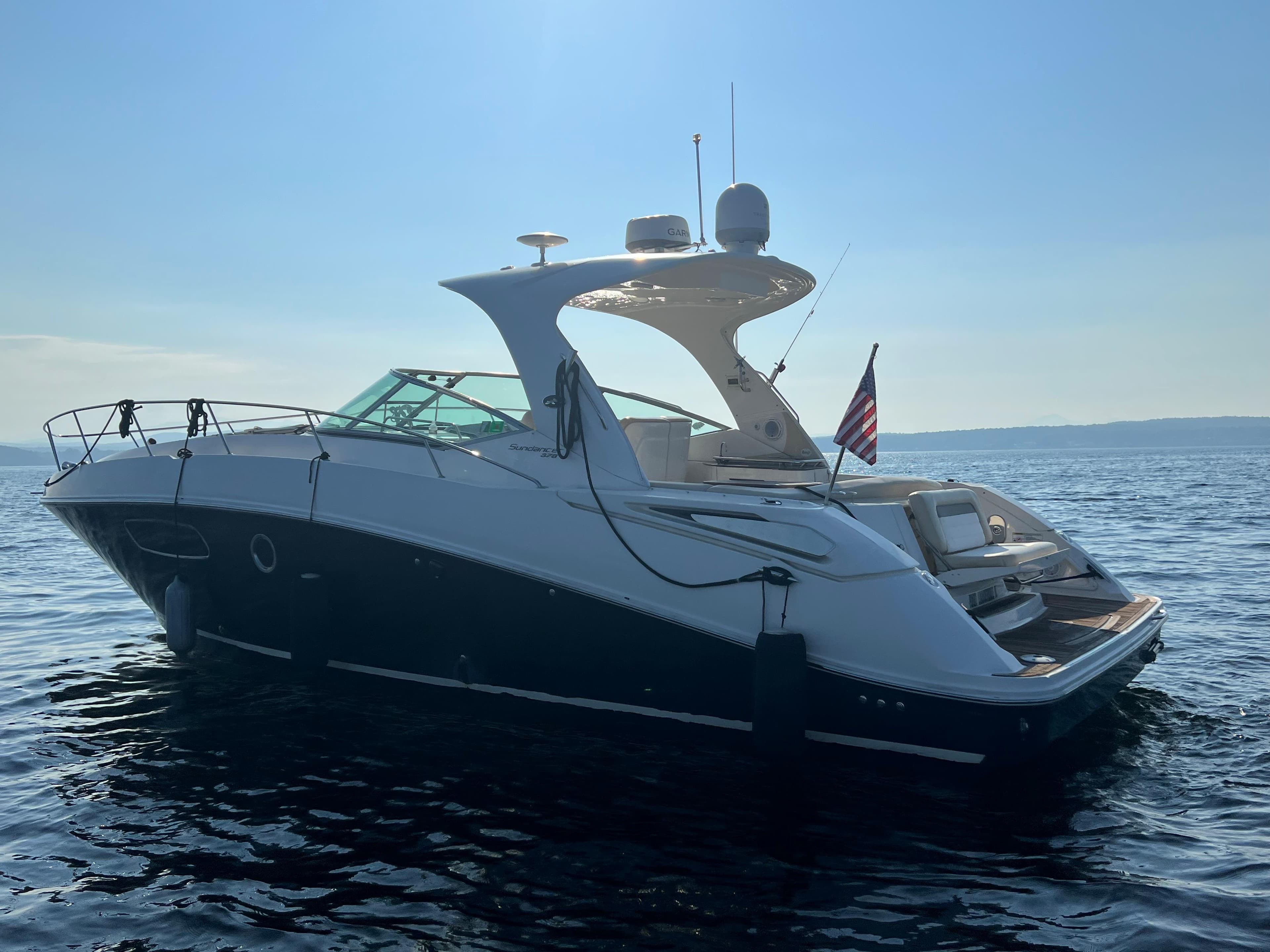 2012 Sea Ray Sundancer 370 on calm waters at sunset.