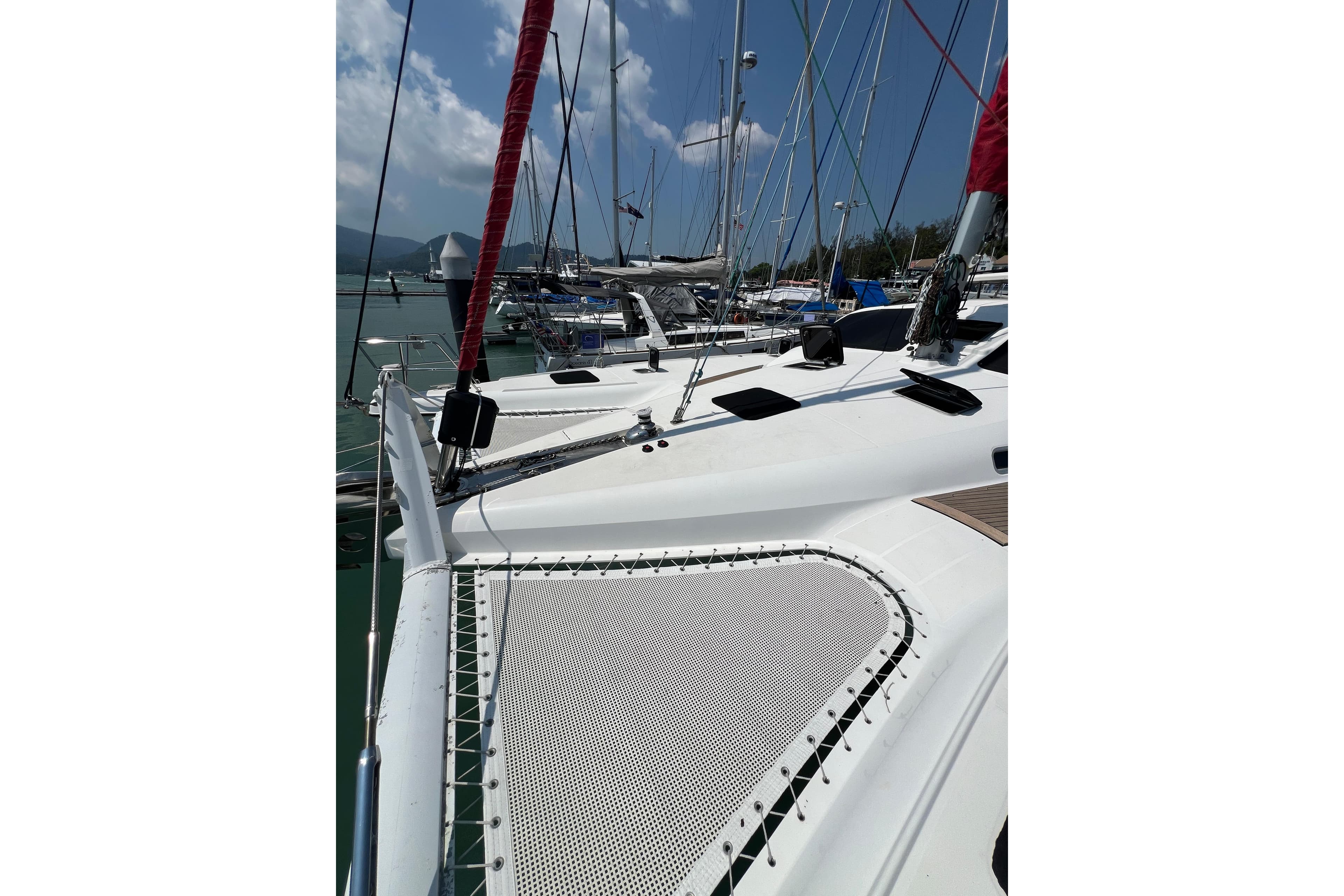 Sailing catamaran Privilege 495, 2007 model, docked at marina under clear sky.