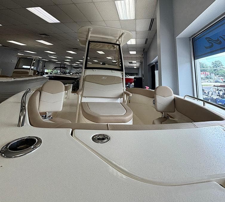2024 Scout 215 XSF boat interior with seating and helm station in showroom.