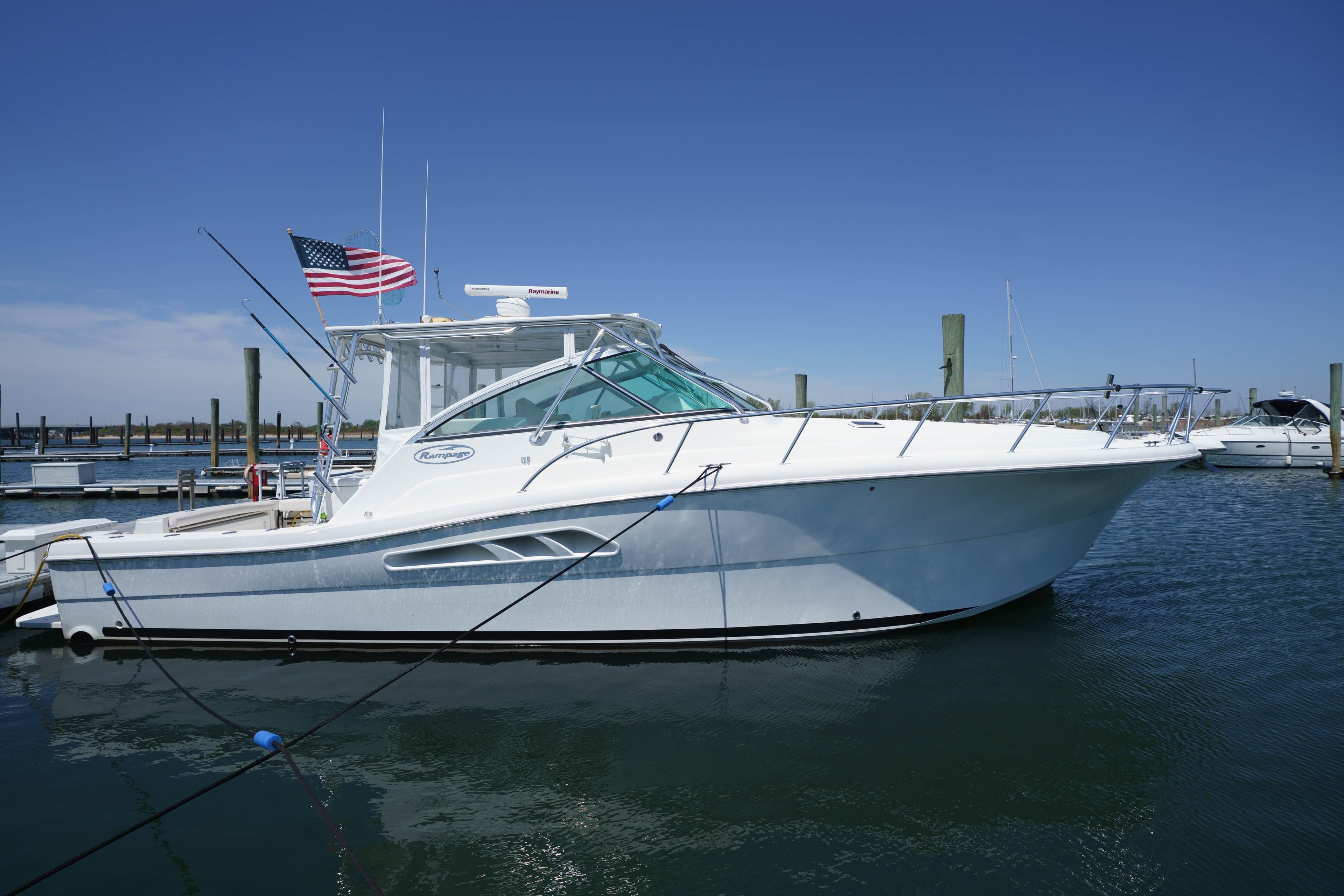 2011 Rampage 41 Express yacht docked in marina, clear blue sky.