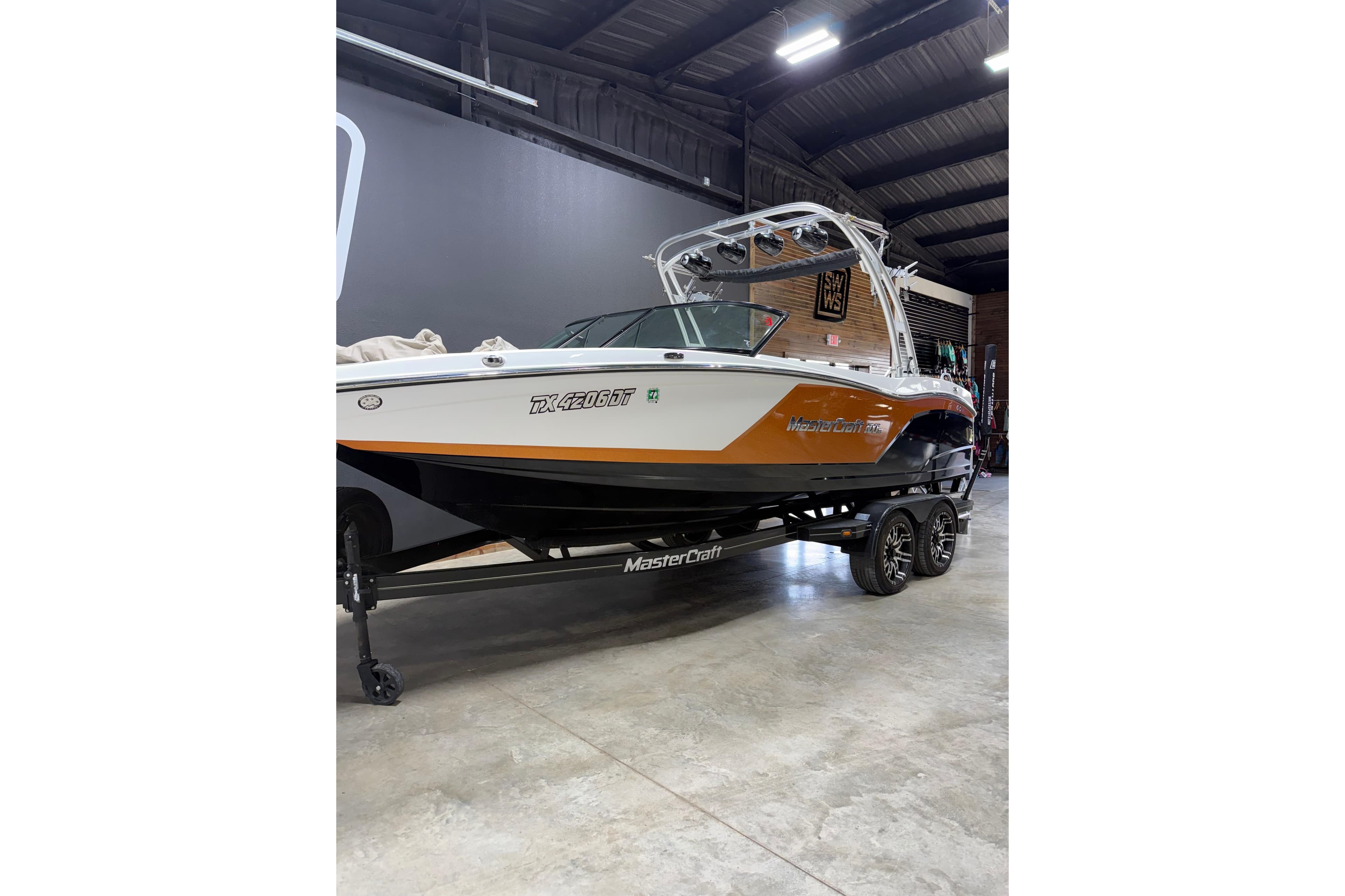 2017 MasterCraft NXT22 boat on trailer in indoor storage facility.