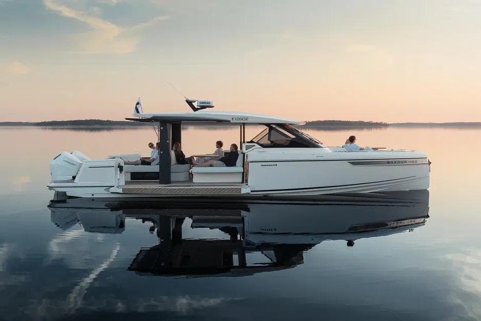 2026 Saxdor 400 GTO yacht on calm water at sunset, featuring sleek design and luxury.