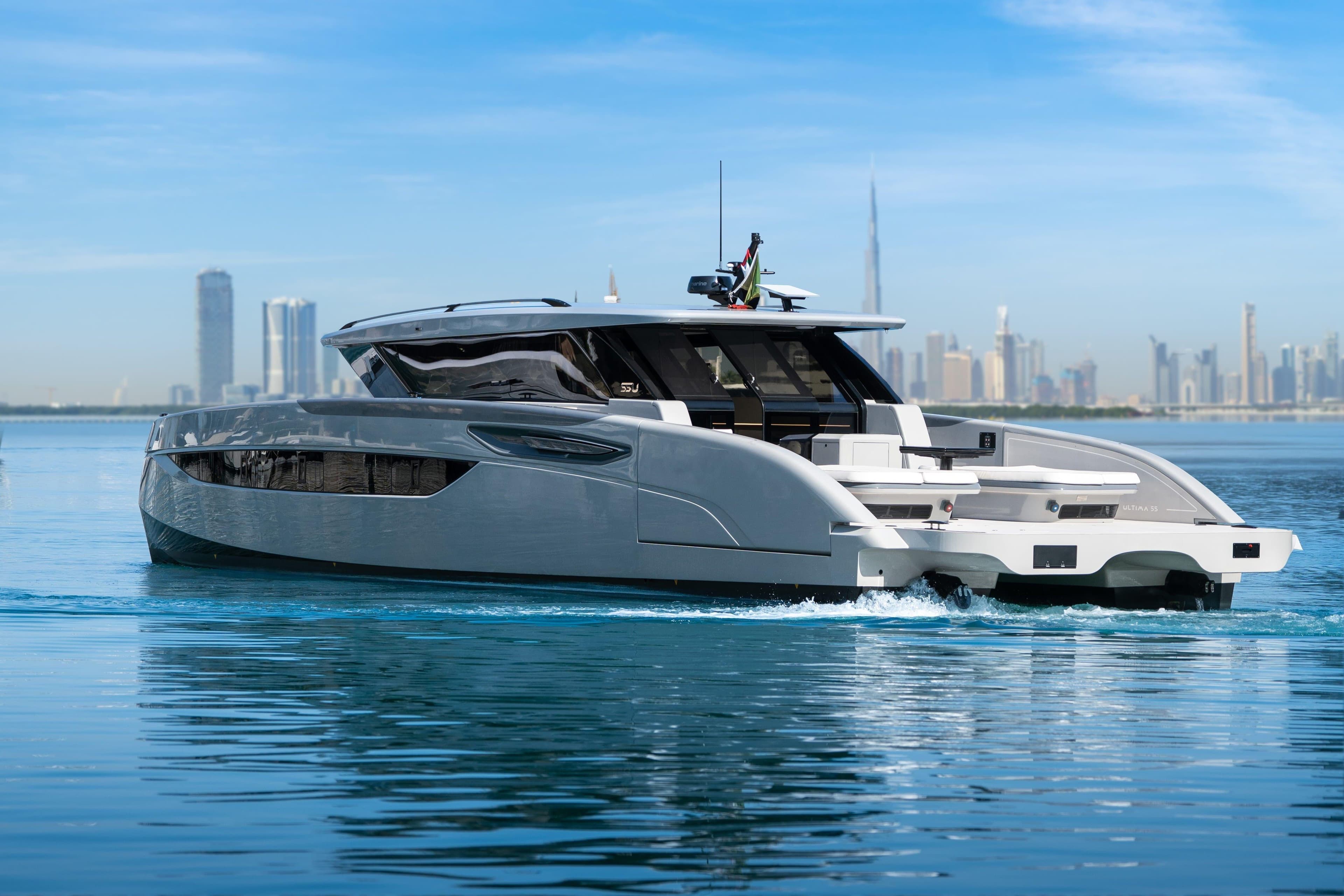 2025 Sunreef 55 ULTIMA luxury yacht cruising near a modern city skyline.