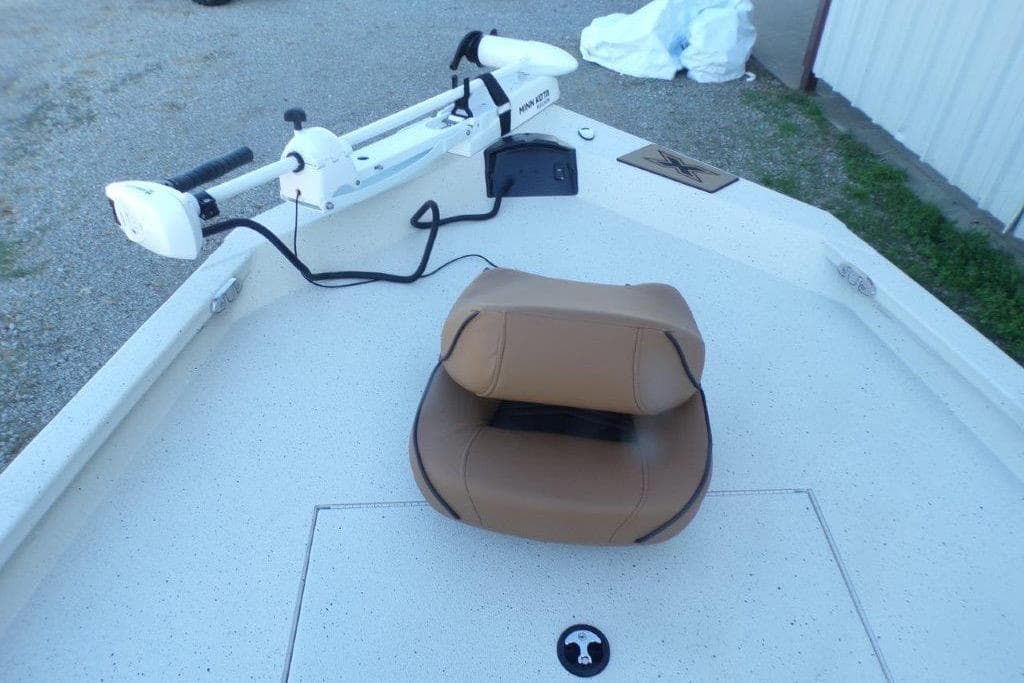 2026 Xpress H20B Bay boat deck with tan seat and trolling motor.