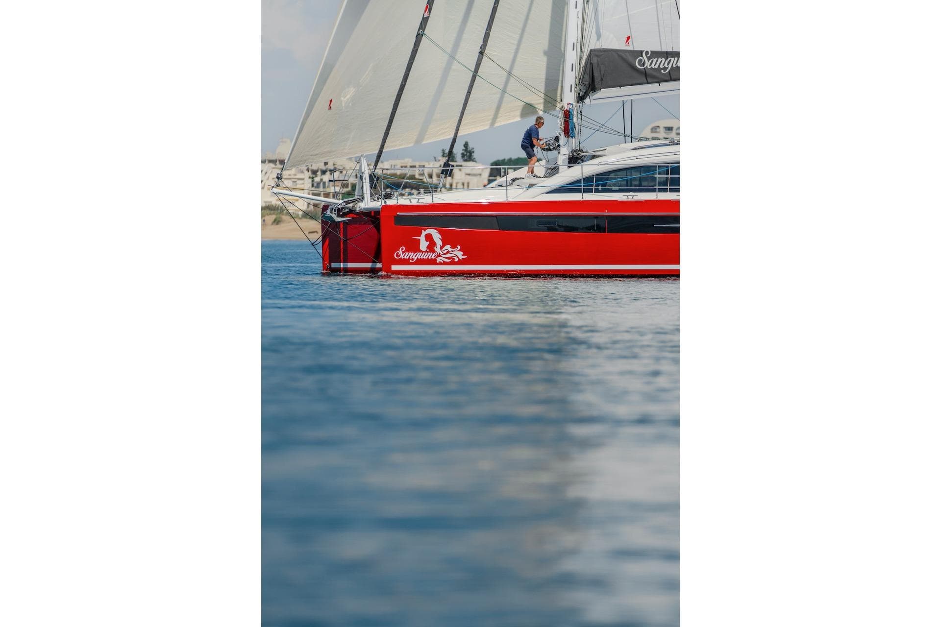 Red Privilege Signature 510 sailboat on calm water, year 2025.